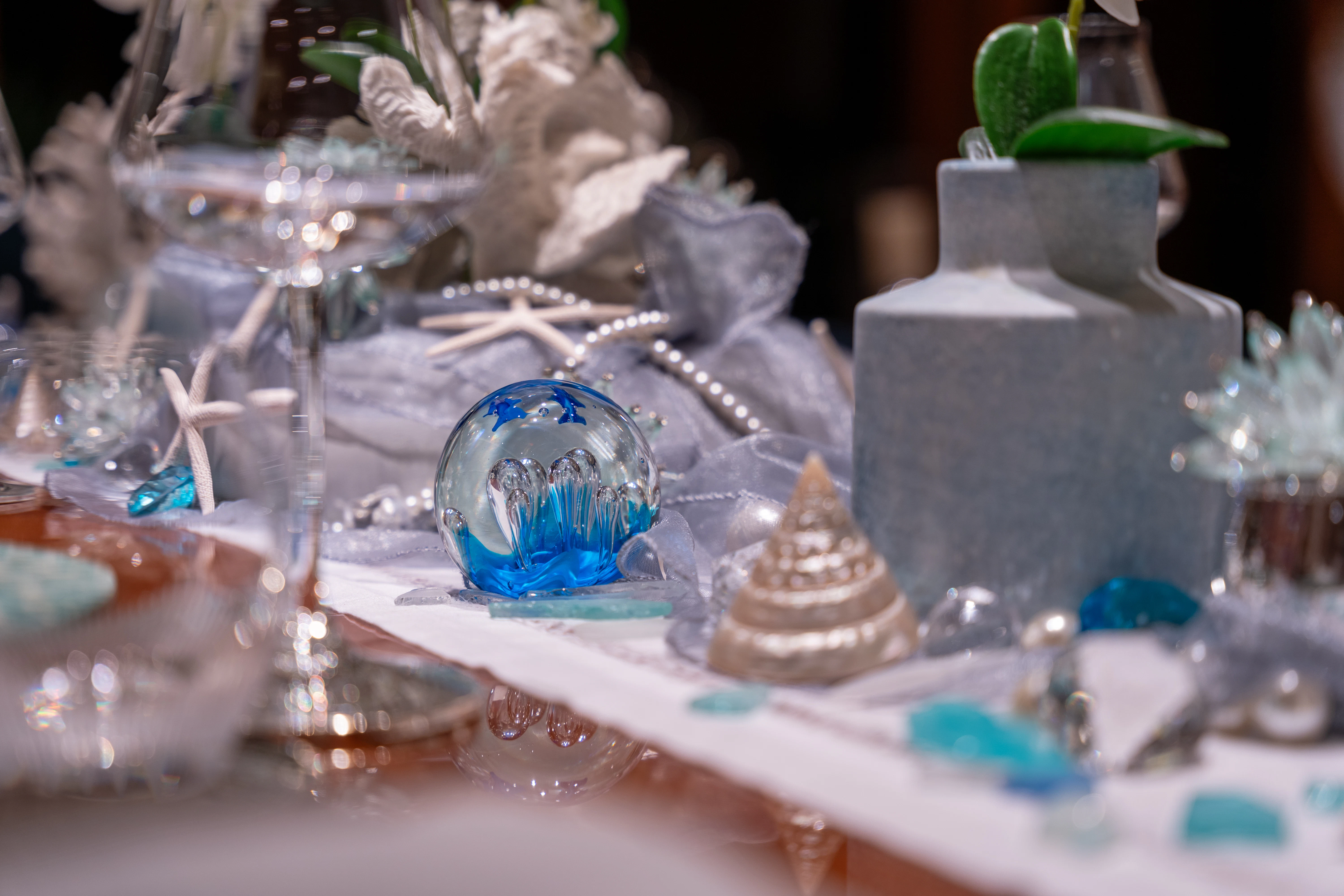 a glass table with a glass vase and a candle aboard AMICA MEA Yacht for Sale