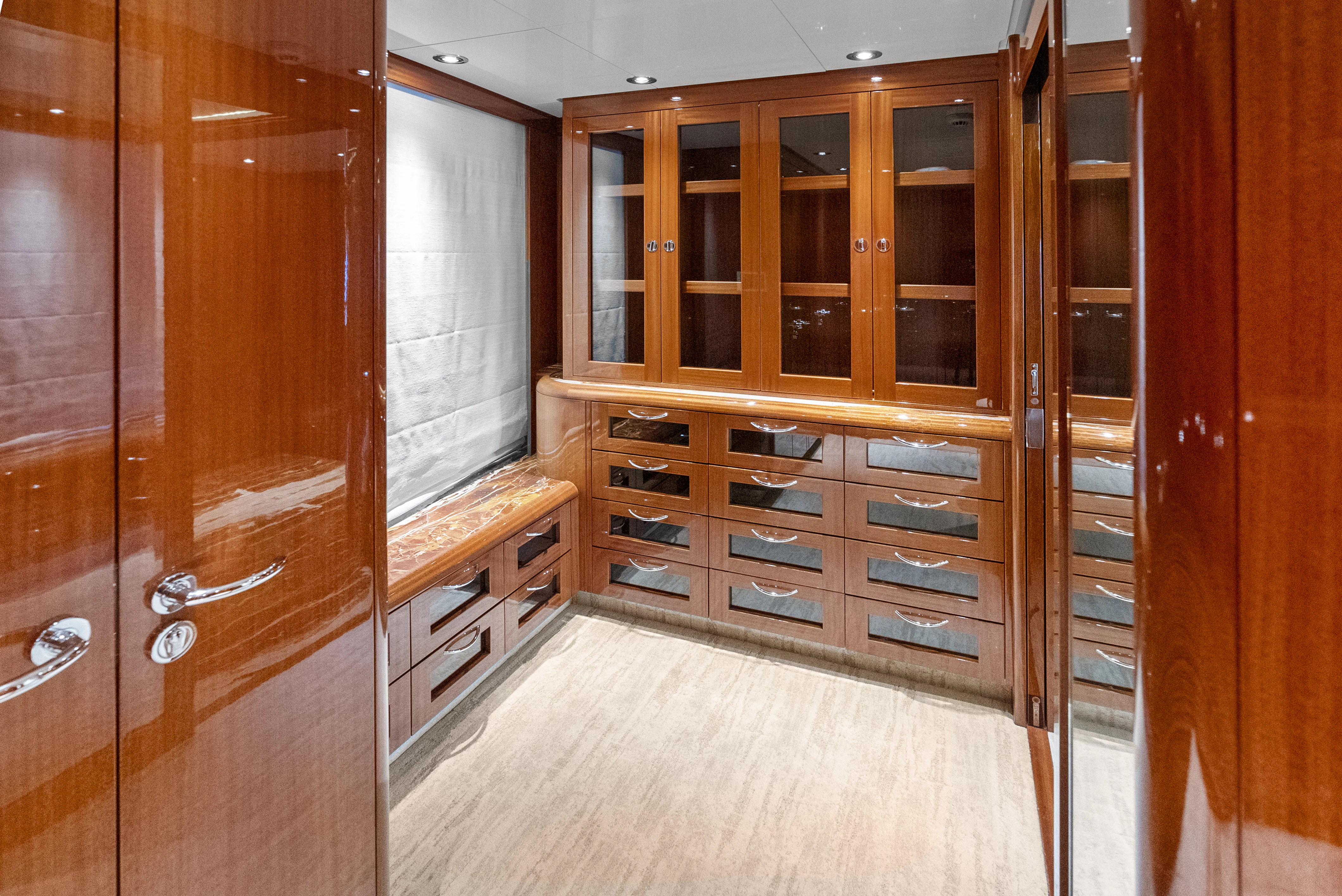 a room with wooden cabinets aboard AMICA MEA Yacht for Sale
