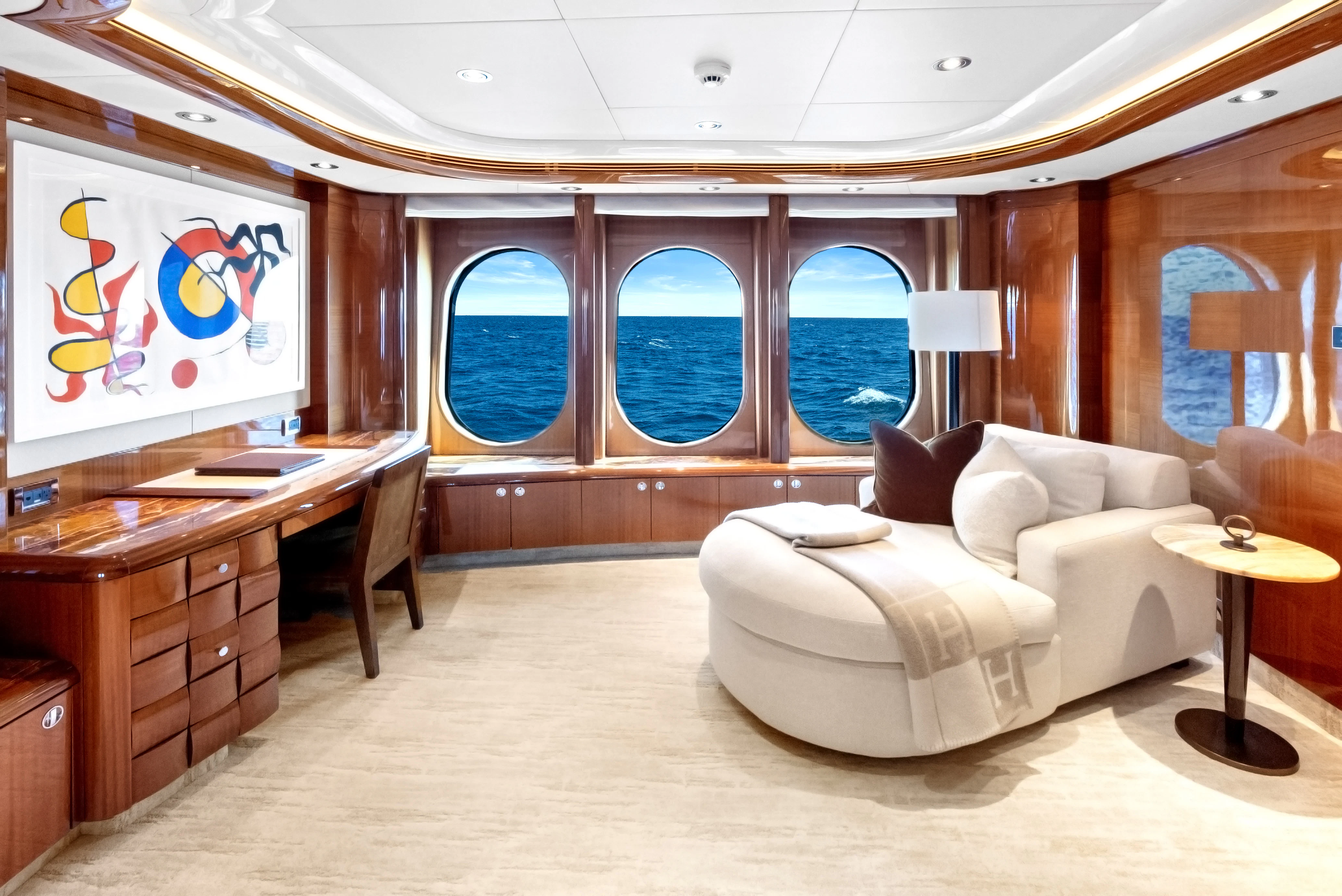 a living room with a couch and a table aboard AMICA MEA Yacht for Sale