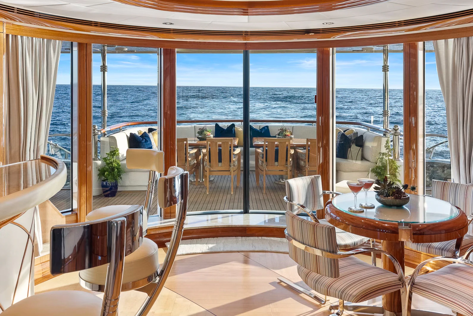 a room with a table and chairs aboard AMICA MEA Yacht for Sale