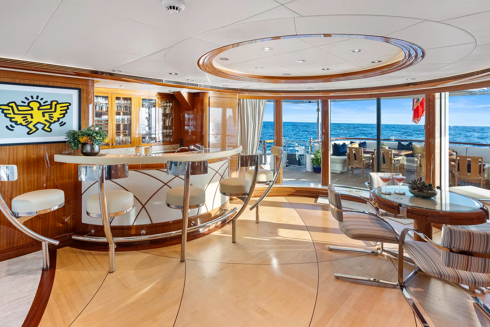 a room with a table chairs and a large window aboard AMICA MEA Yacht for Sale