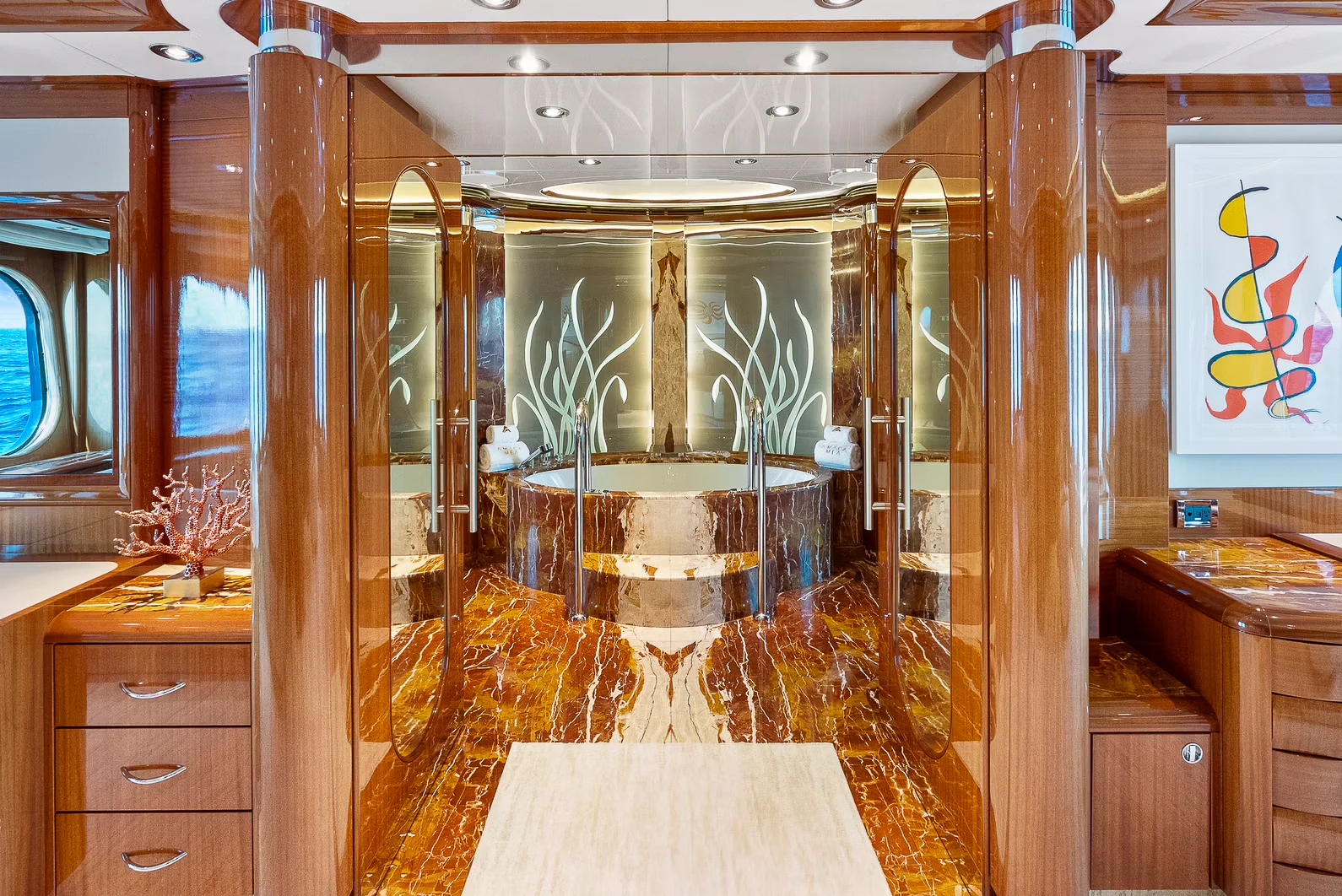 a room with wooden cabinets and a large mirror aboard AMICA MEA Yacht for Sale