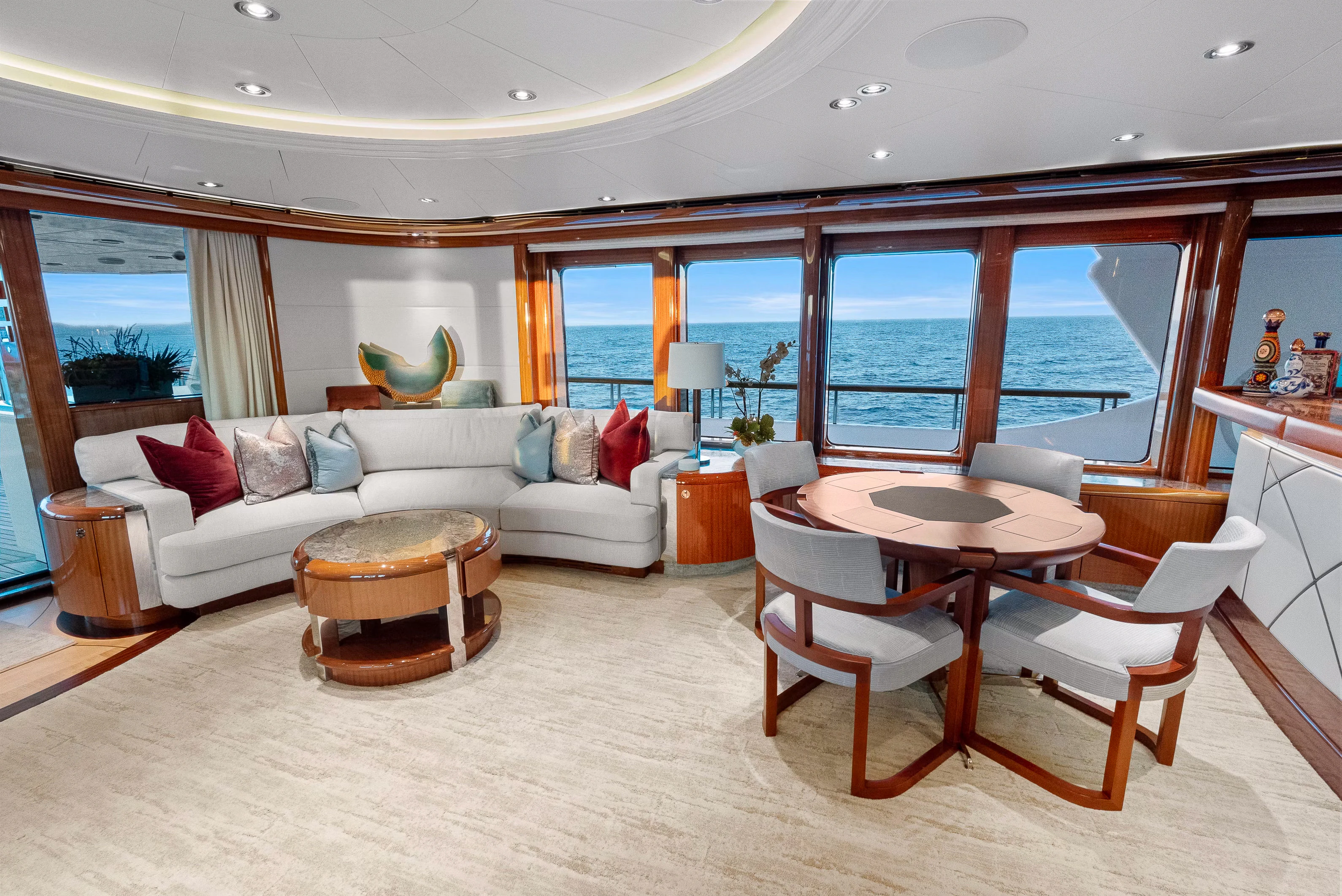 a living room with a couch and a table aboard AMICA MEA Yacht for Sale