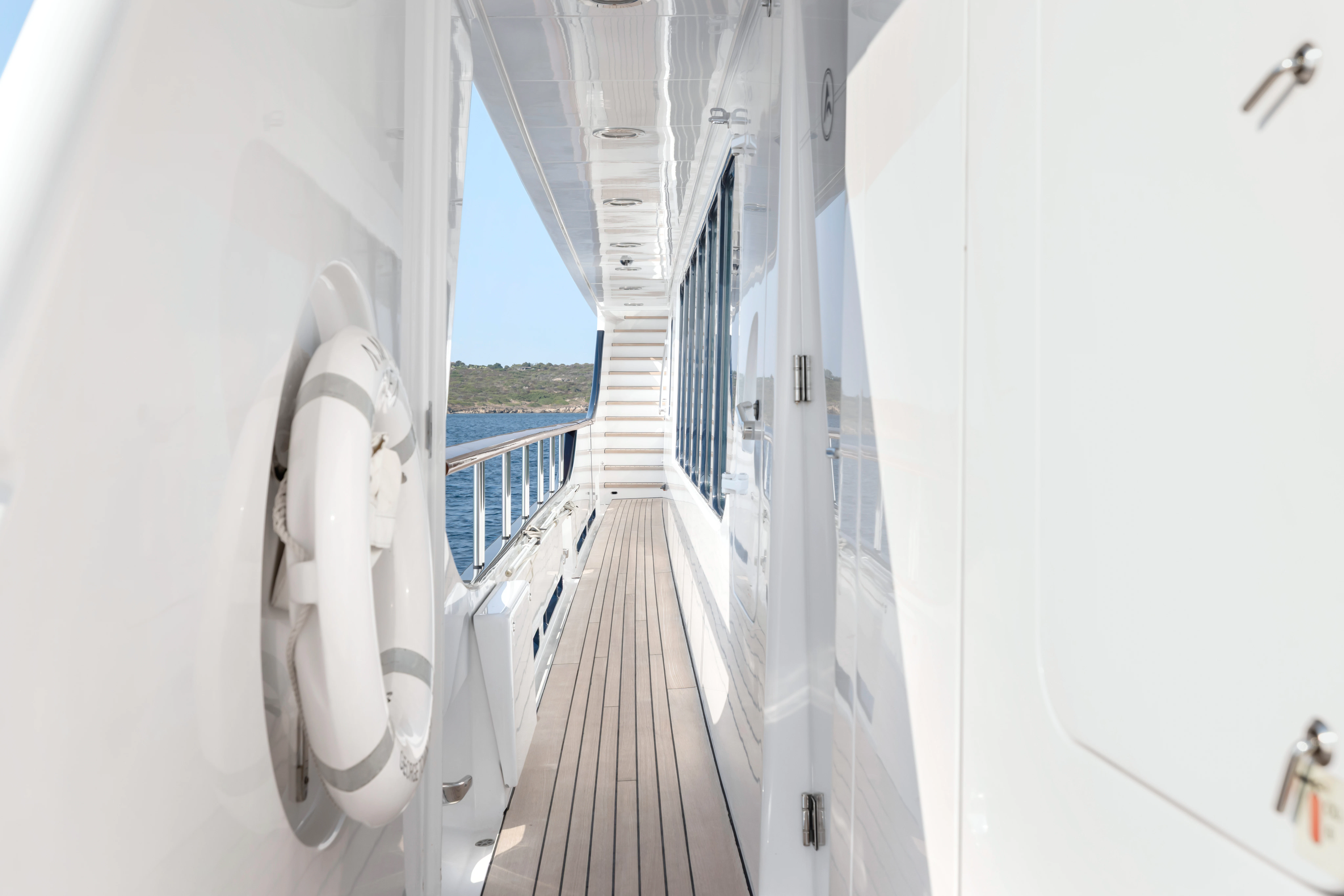 a long hallway with a railing aboard AMICA MEA Yacht for Sale