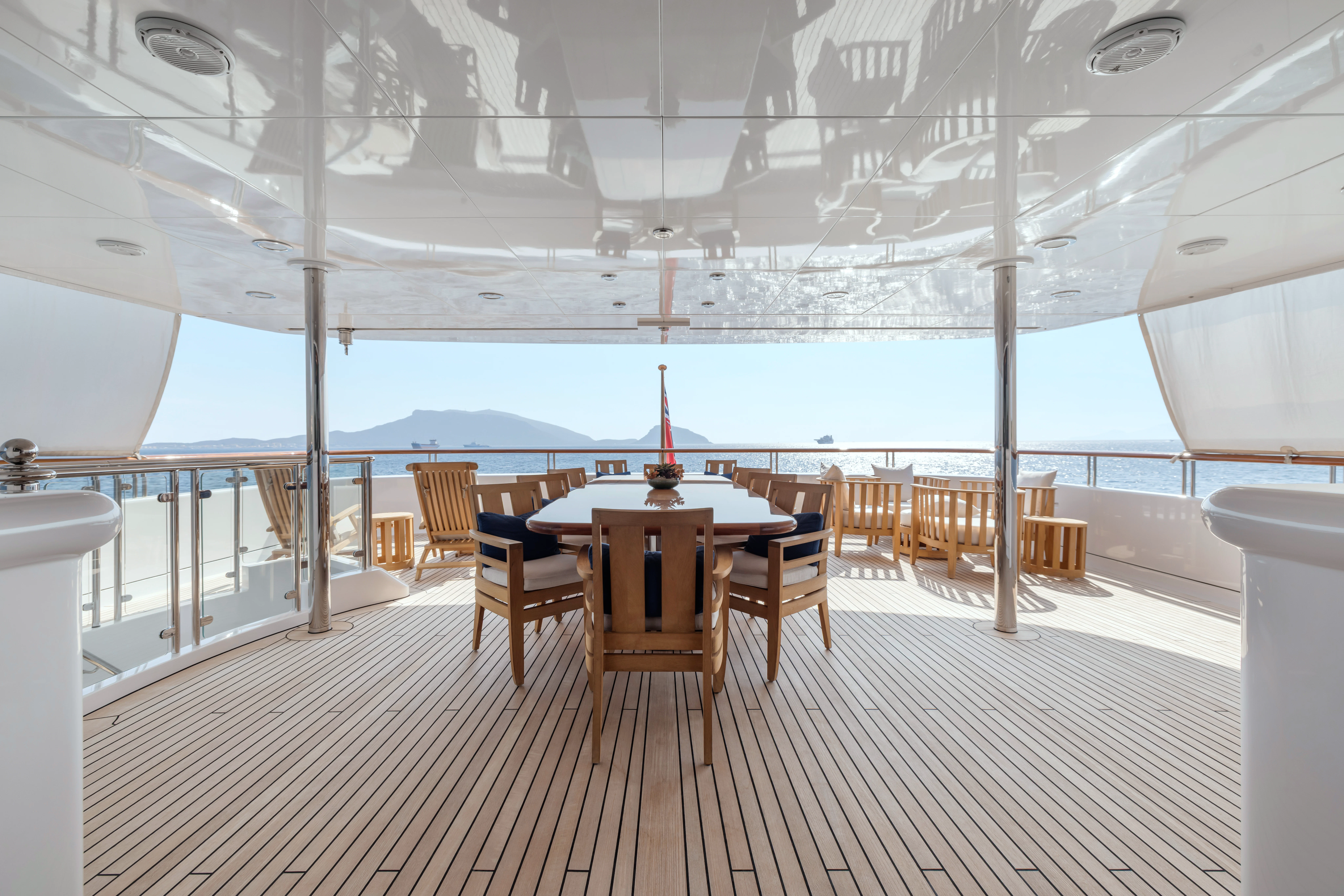 a table and chairs on a deck aboard AMICA MEA Yacht for Sale