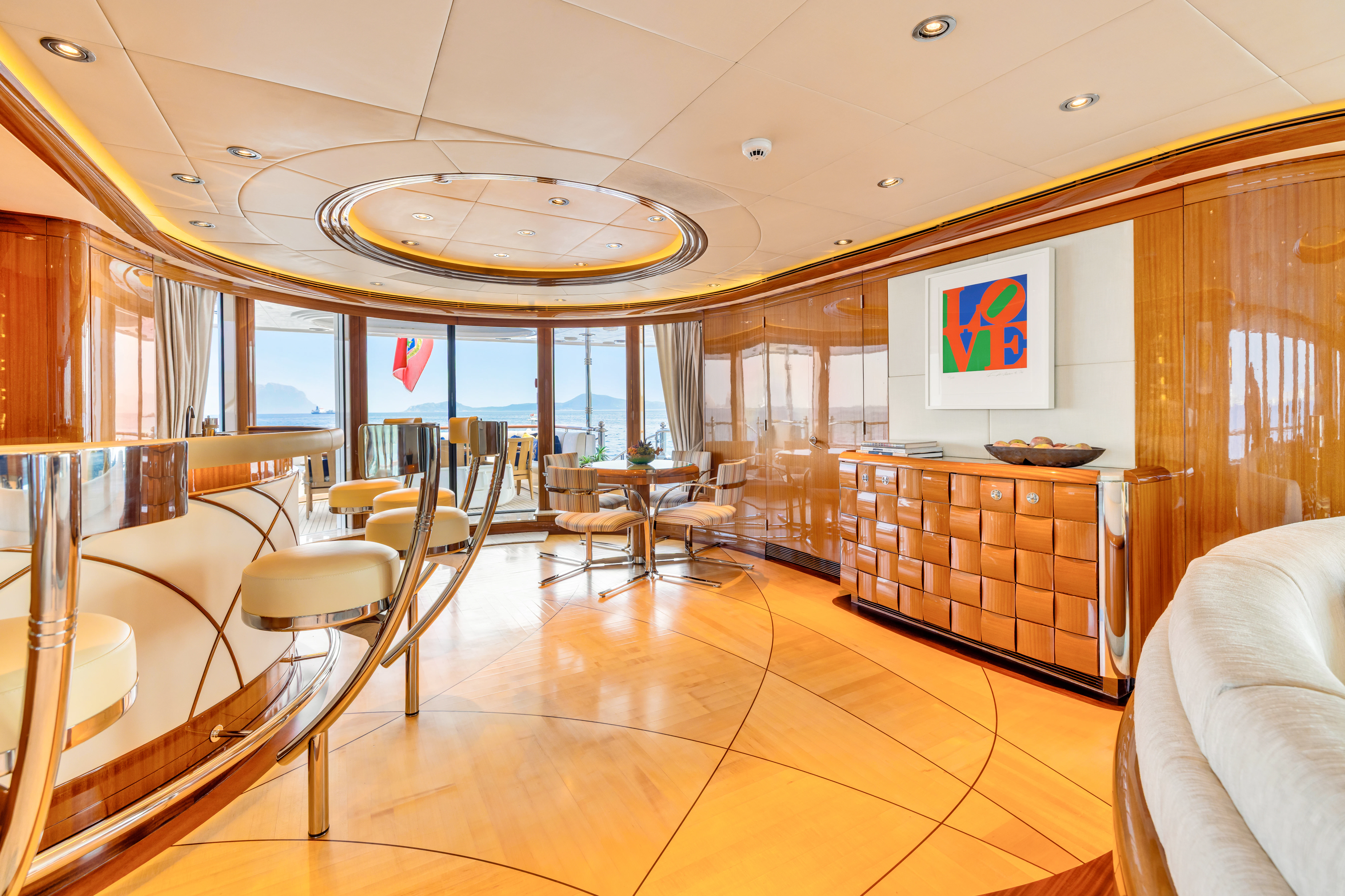 a large room with tables and chairs aboard AMICA MEA Yacht for Sale
