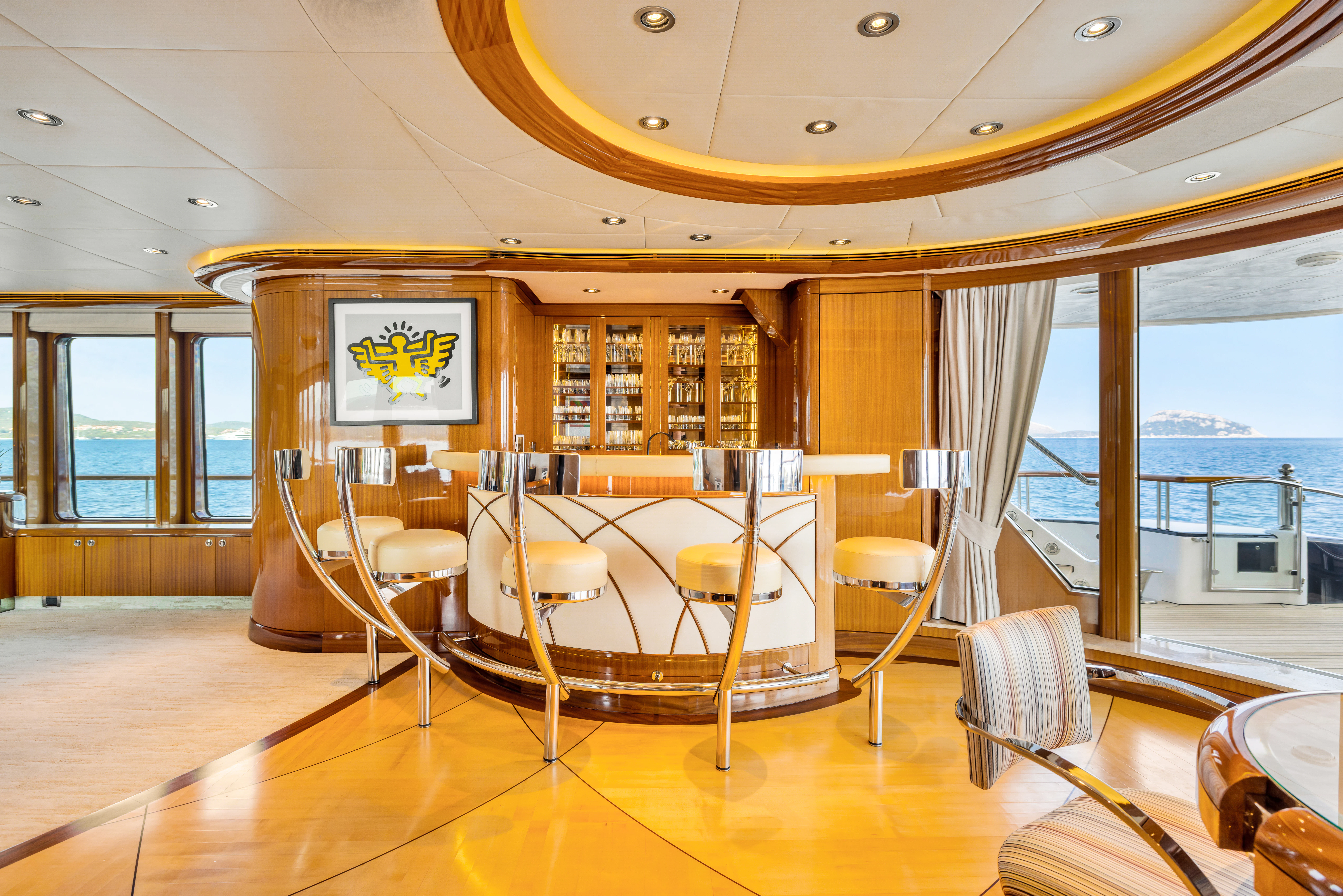 a room with tables and chairs aboard AMICA MEA Yacht for Sale