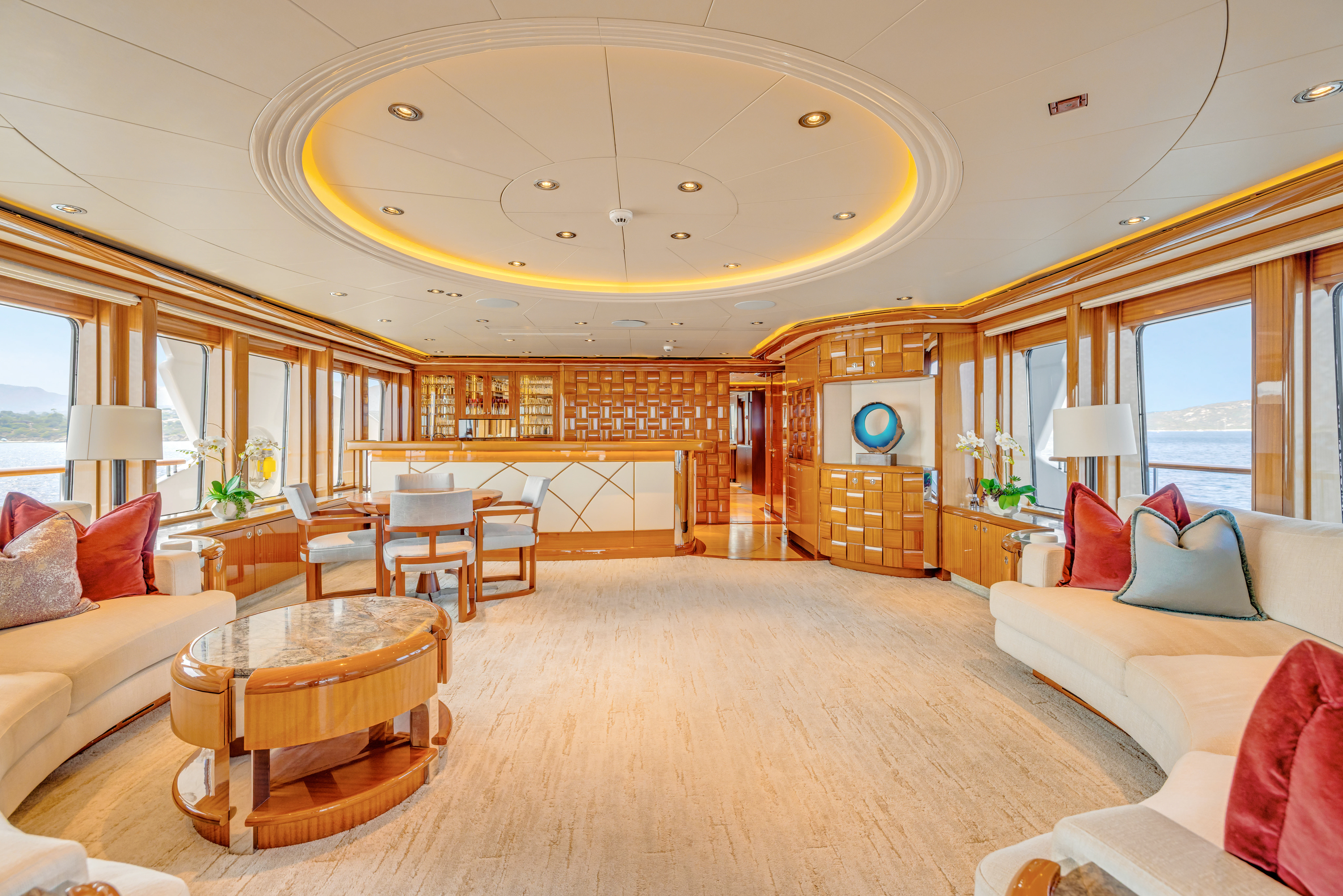 a large living room with a large kitchen and dining area aboard AMICA MEA Yacht for Sale