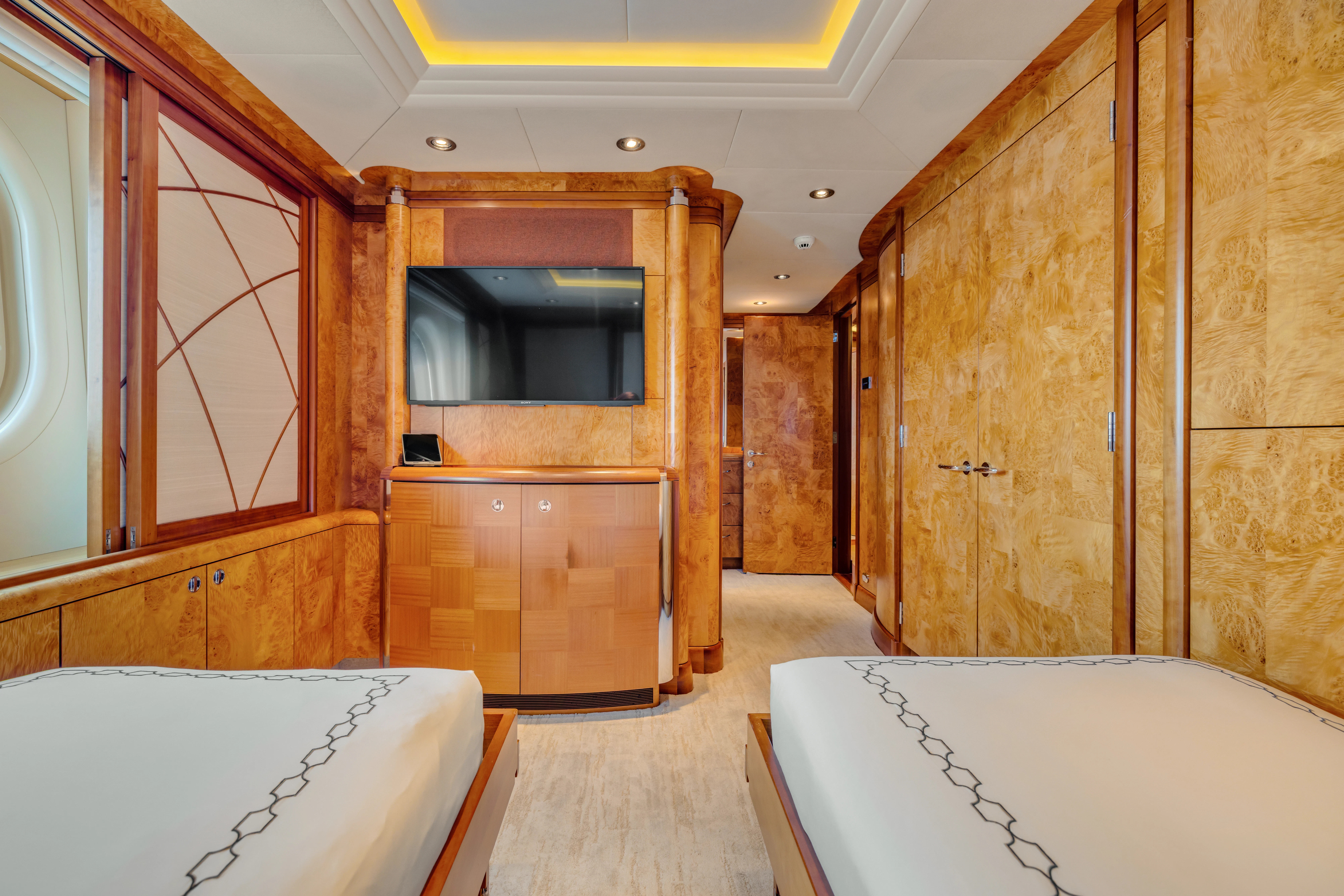 a room with wooden walls and a white rug aboard AMICA MEA Yacht for Sale