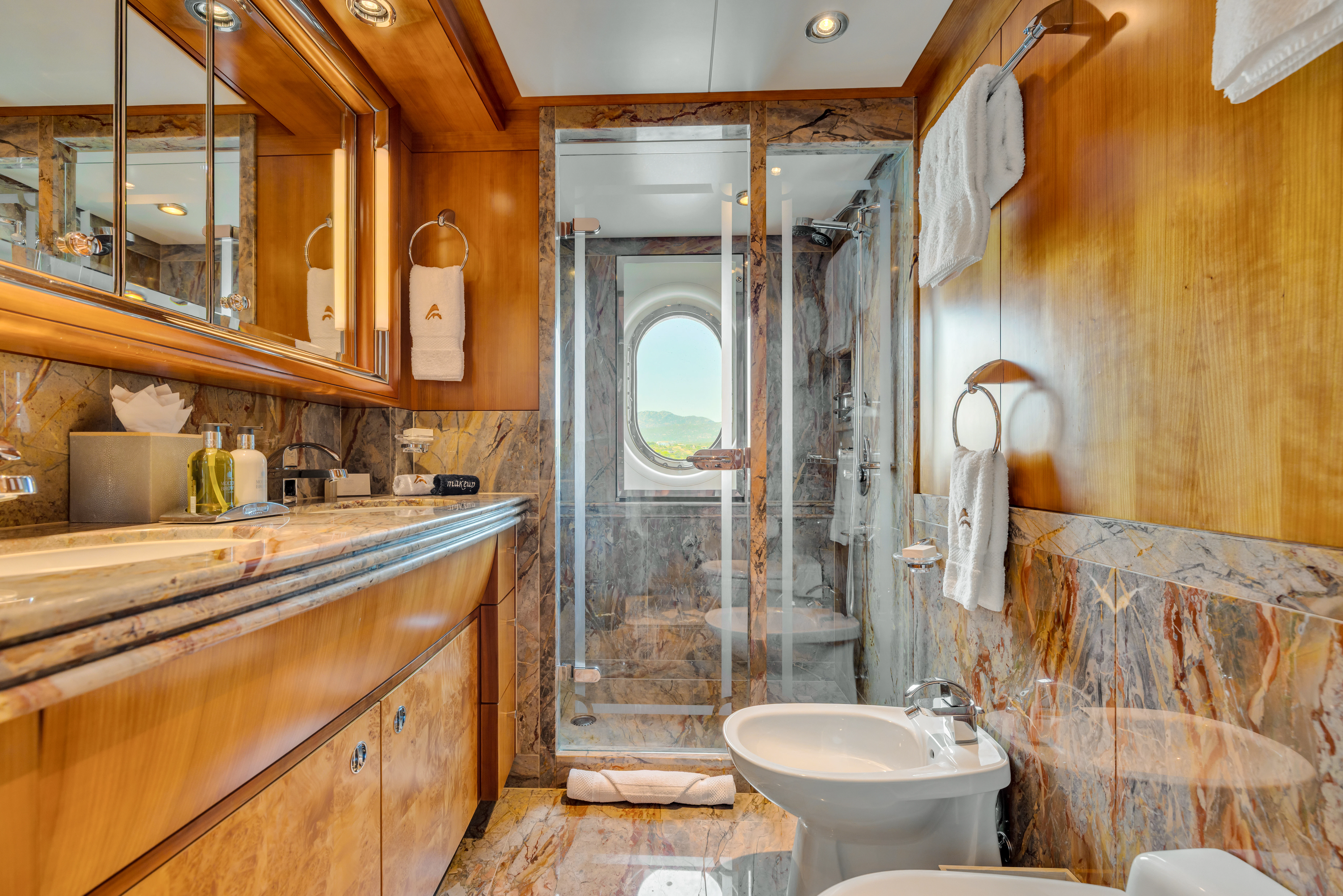 a bathroom with a glass shower aboard AMICA MEA Yacht for Sale