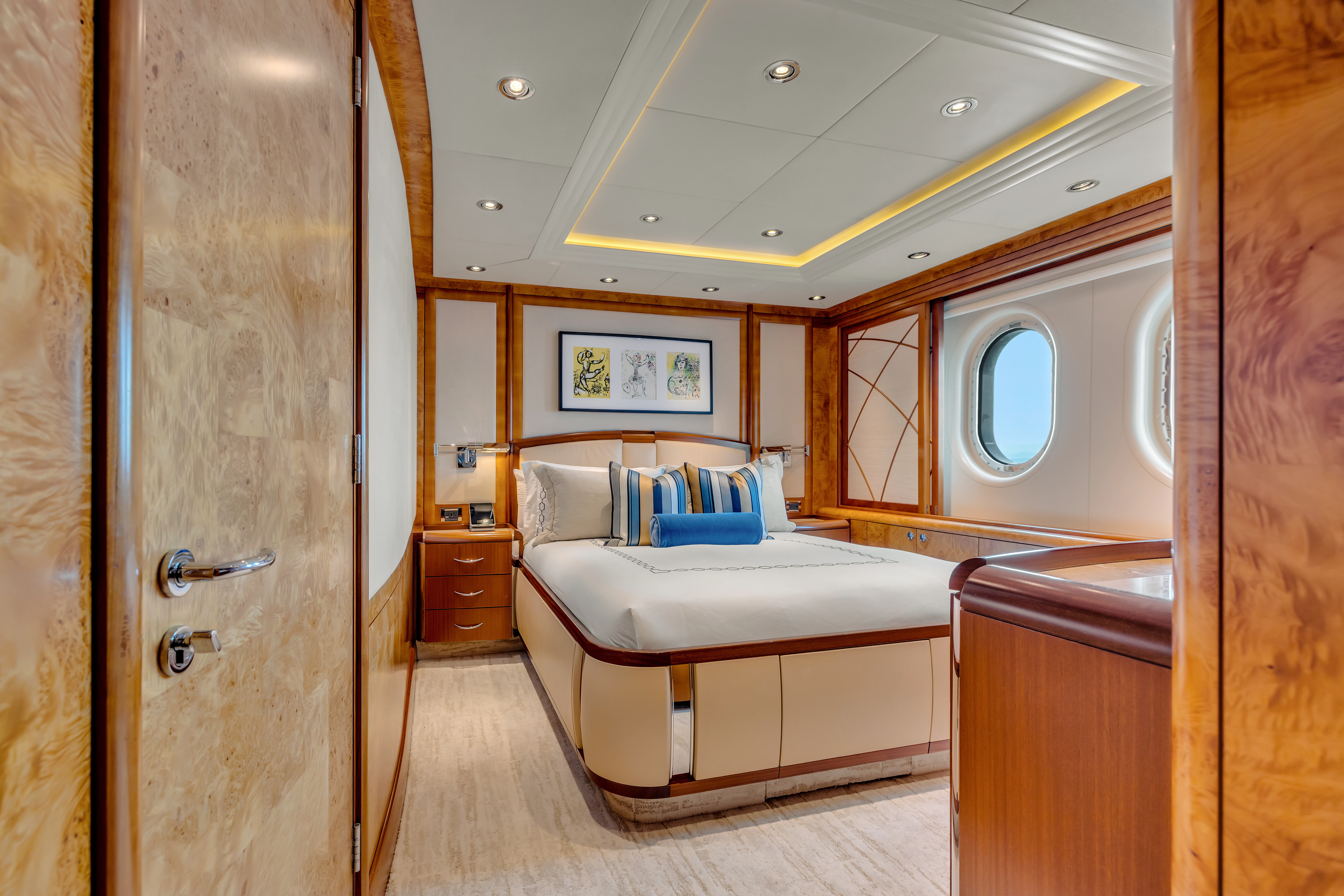 a bedroom with a bed and a mirror aboard AMICA MEA Yacht for Sale