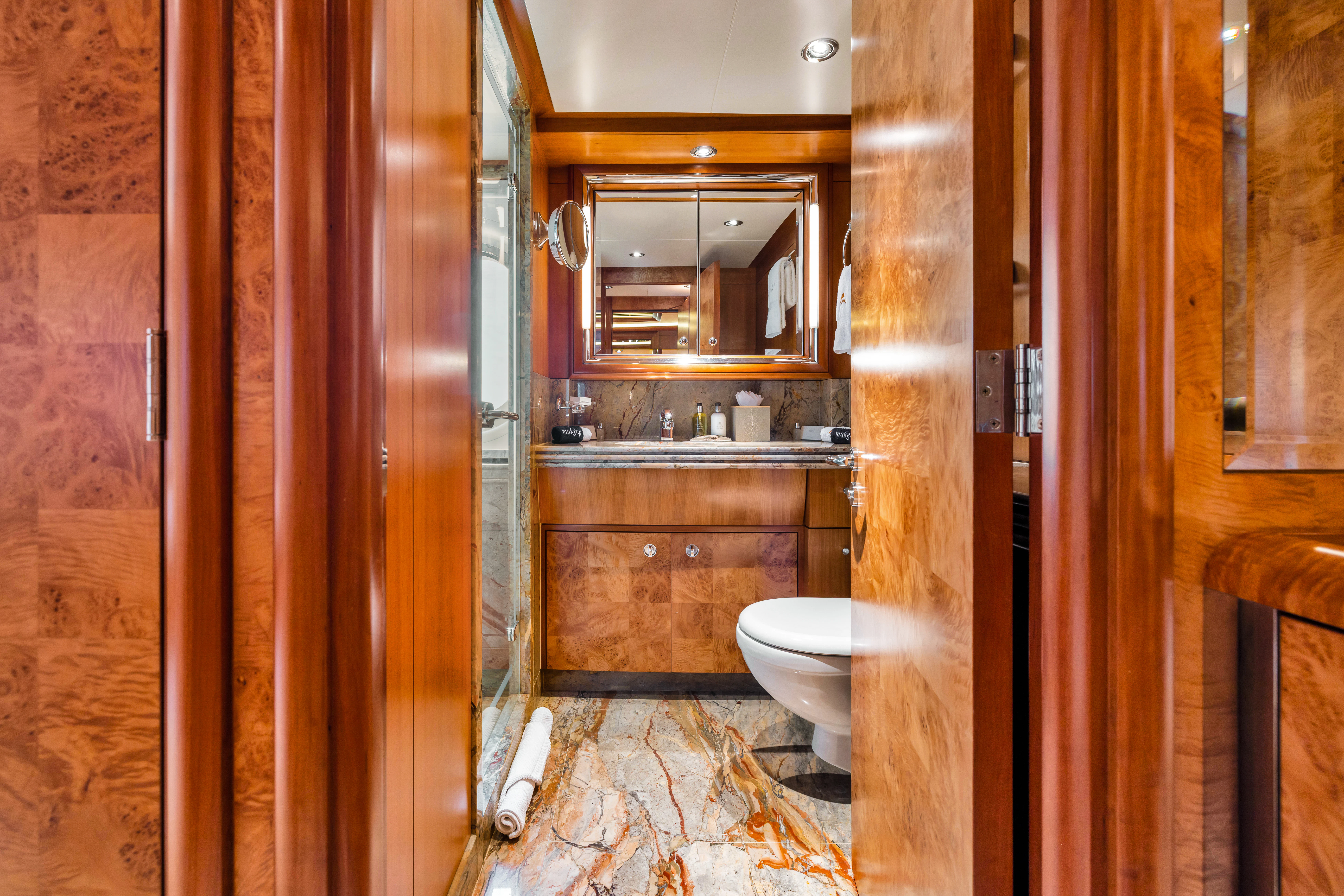 a bathroom with wooden walls aboard AMICA MEA Yacht for Sale