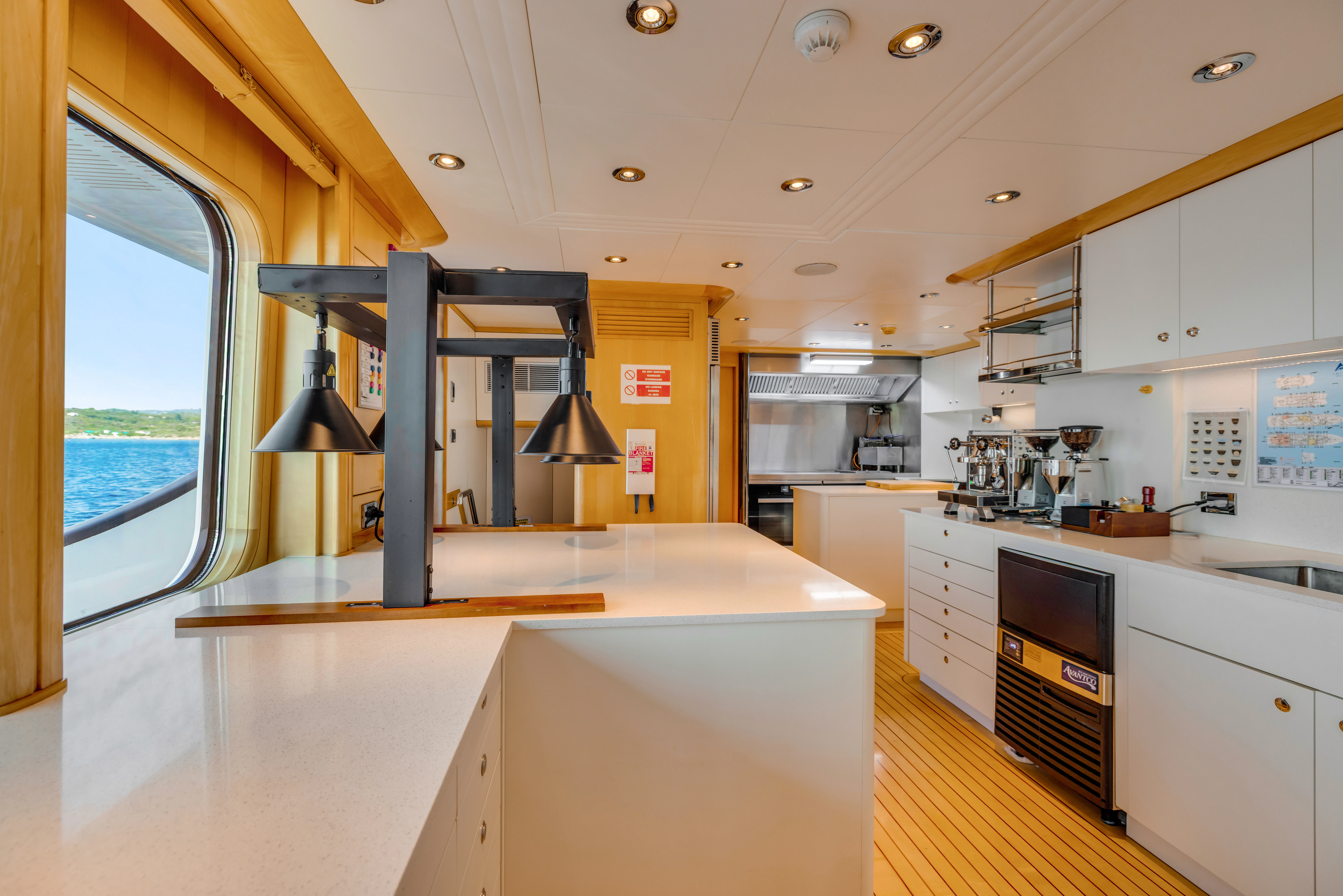 a kitchen with a large window aboard AMICA MEA Yacht for Sale