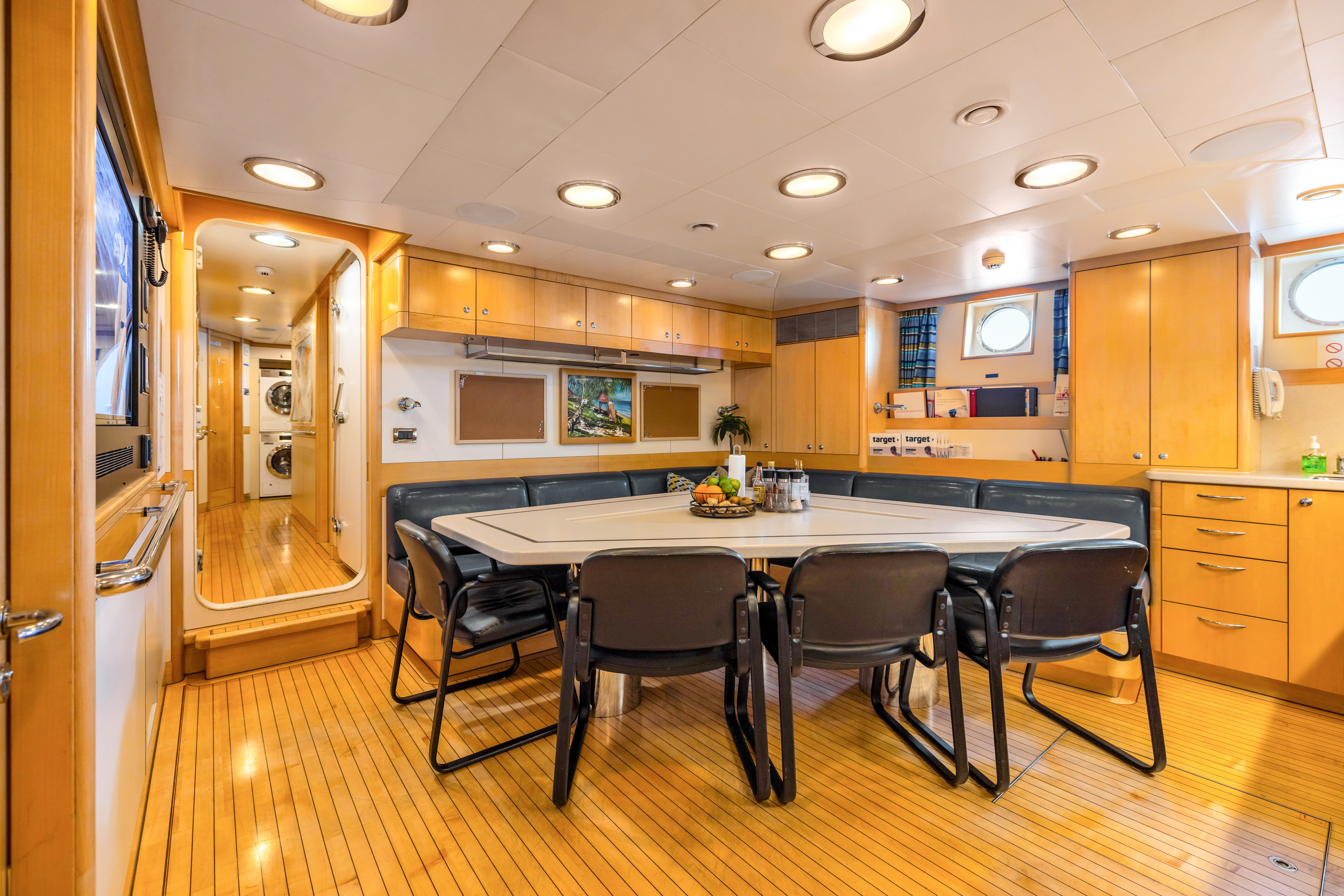 a kitchen with a table and chairs aboard AMICA MEA Yacht for Sale