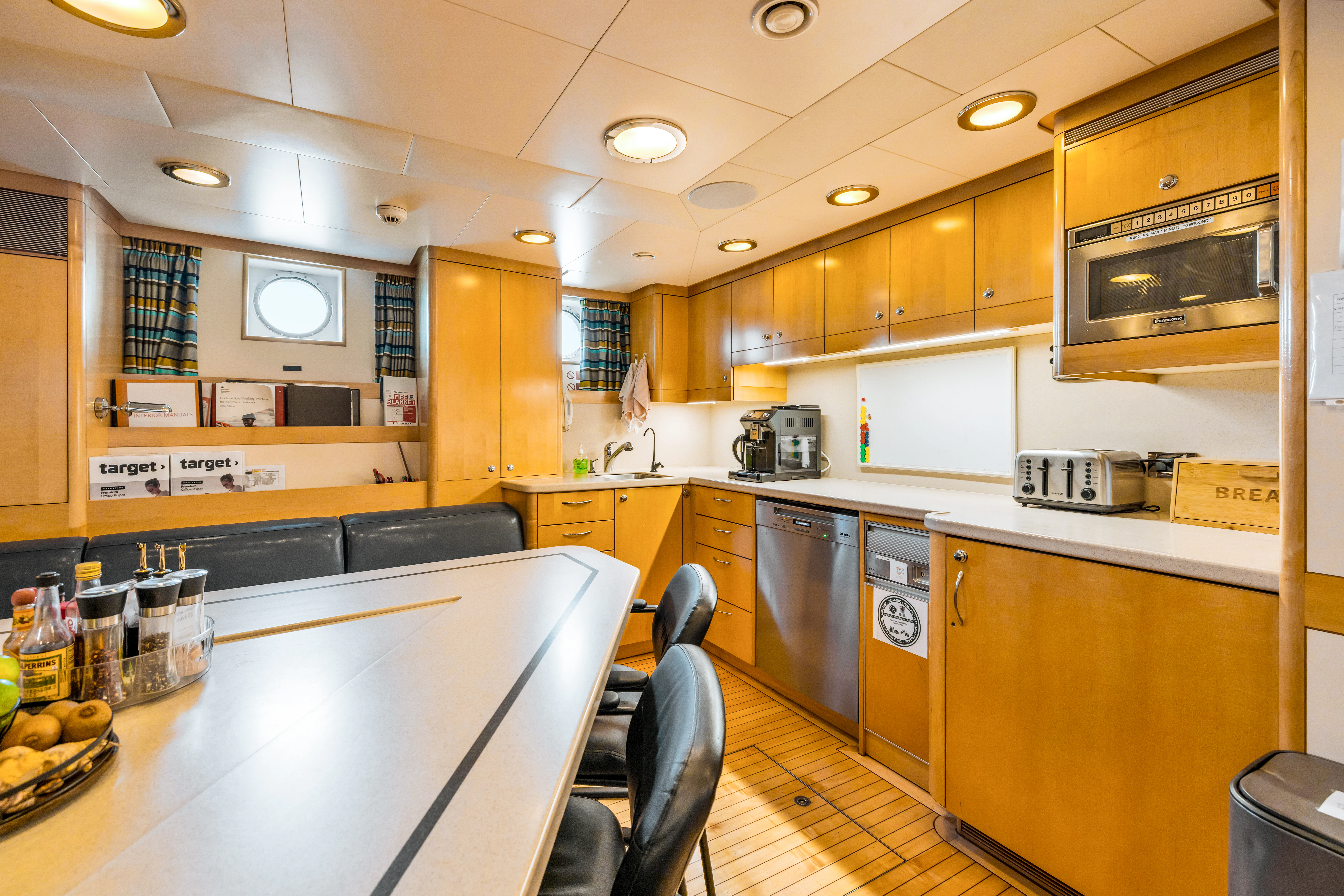 a kitchen with a large island aboard AMICA MEA Yacht for Sale