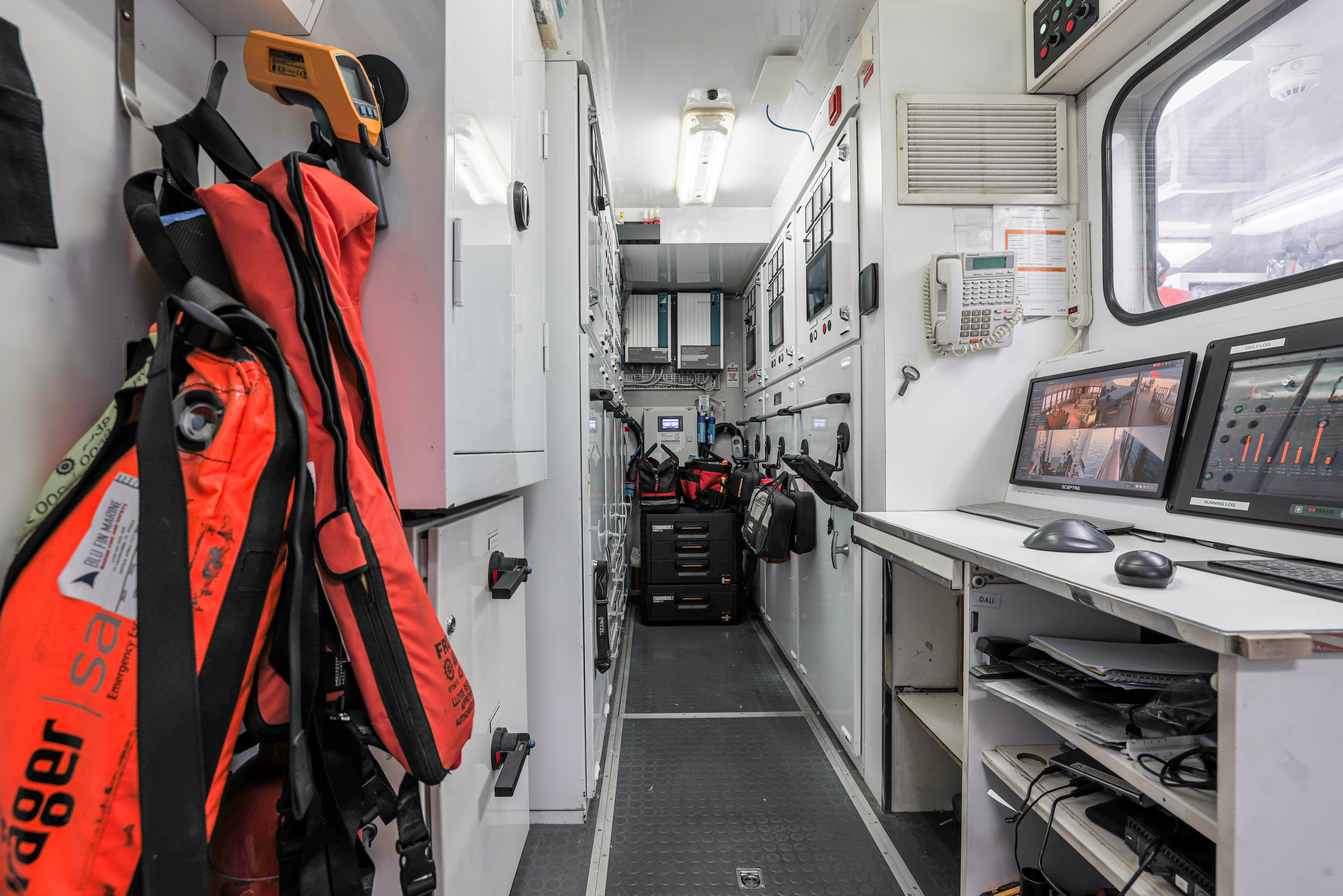 a hallway with a computer and other equipment aboard AMICA MEA Yacht for Sale