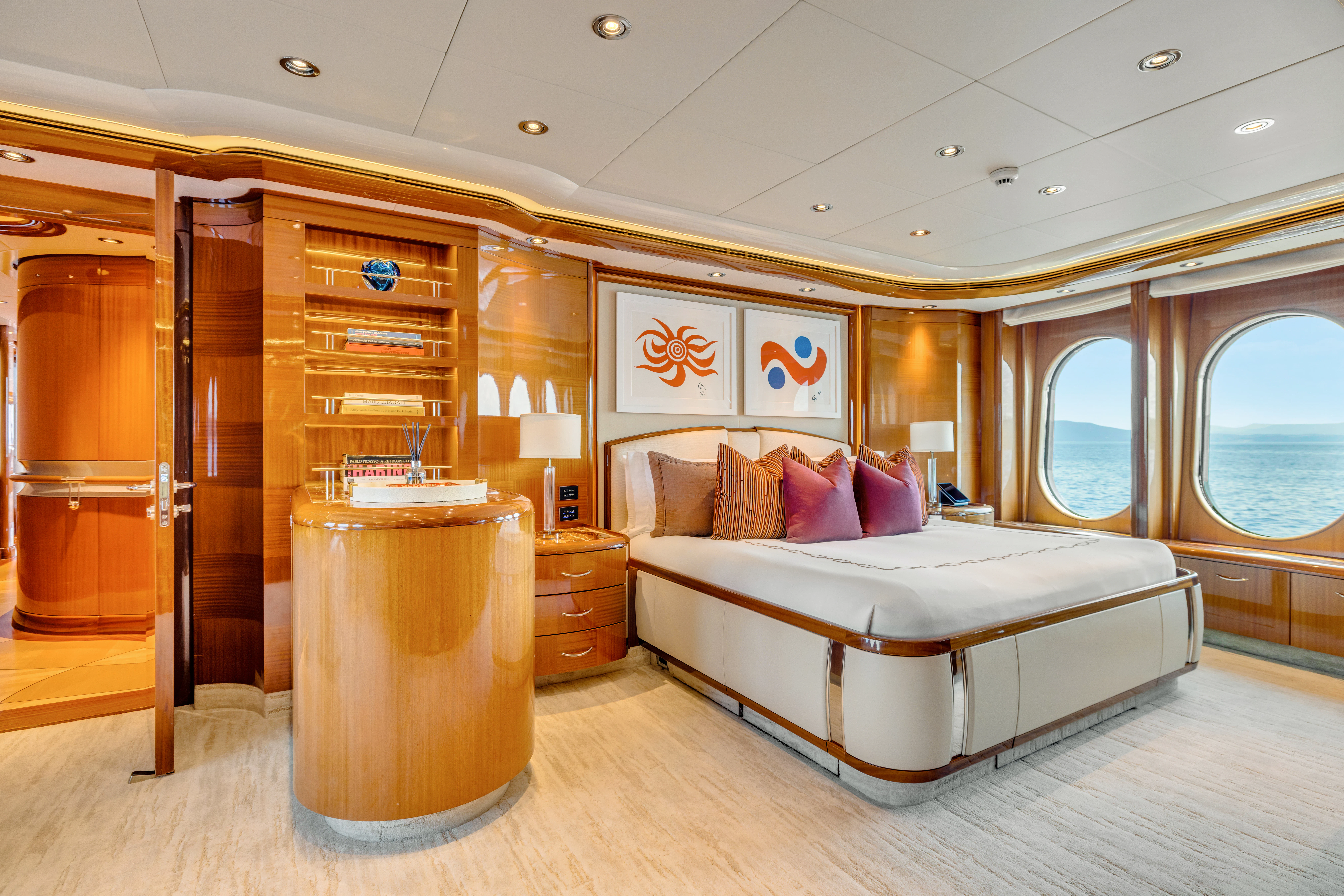 a bedroom with a bed and a large mirror aboard AMICA MEA Yacht for Sale