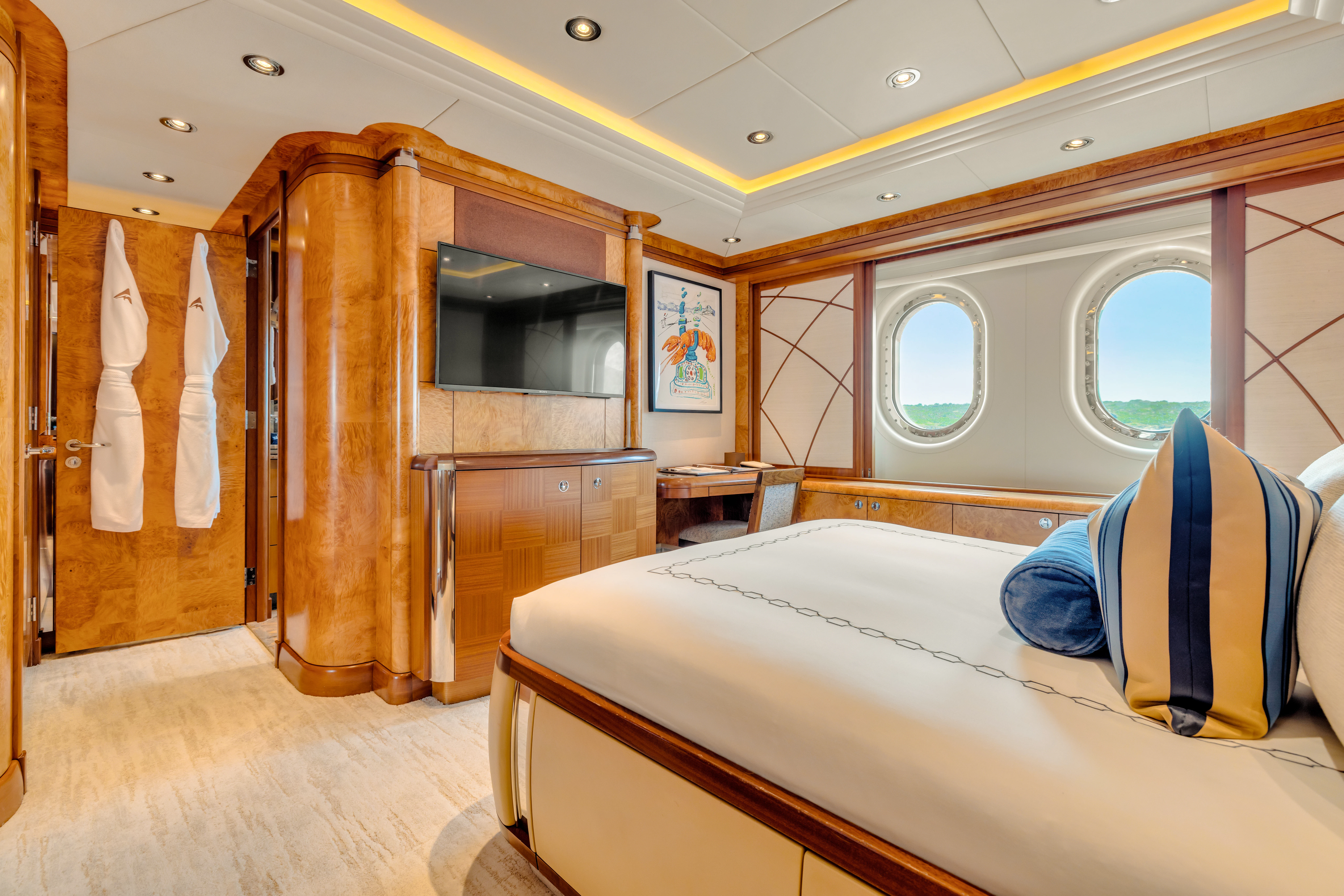 a bedroom with a bed and a wood door aboard AMICA MEA Yacht for Sale