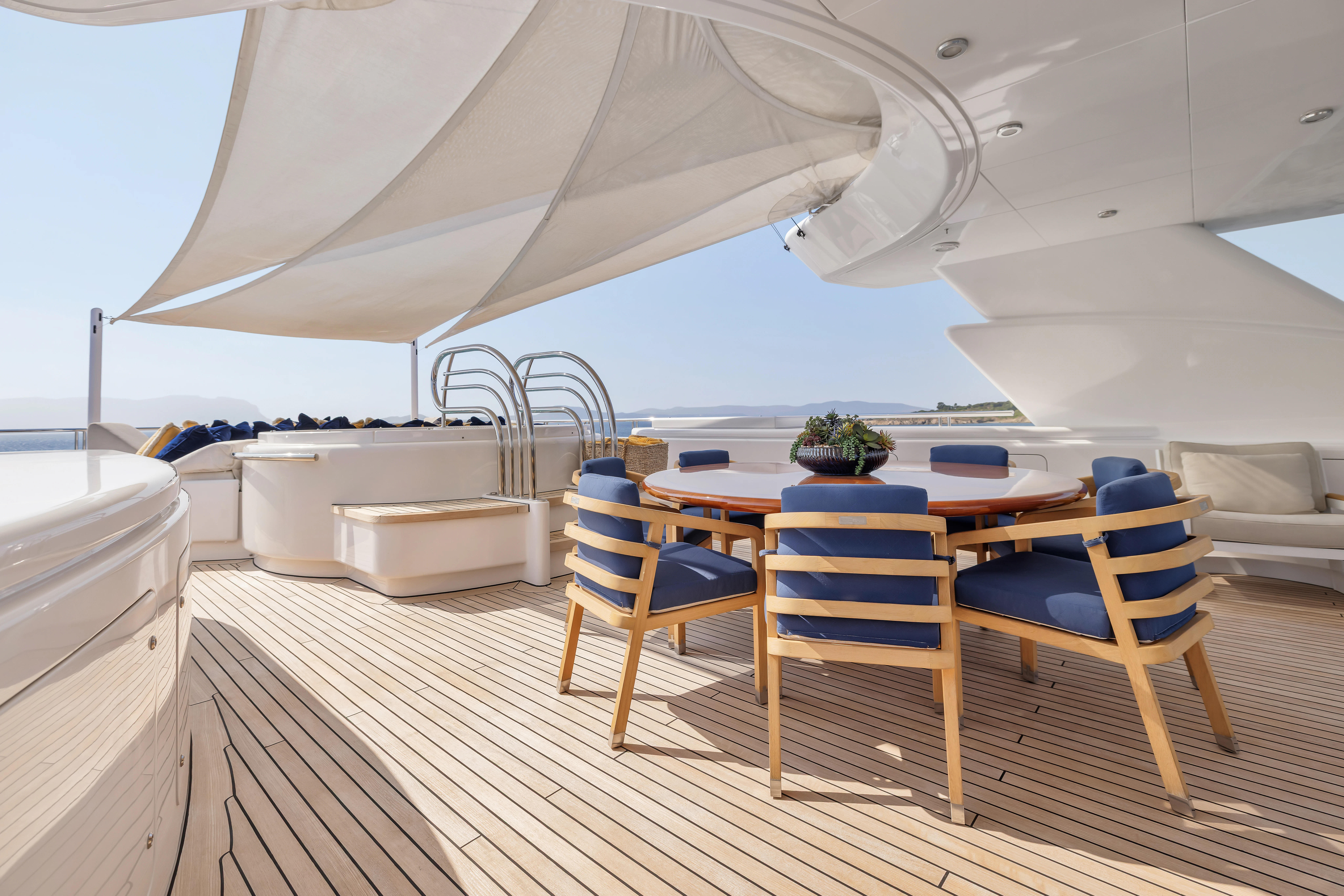 a room with a table and chairs aboard AMICA MEA Yacht for Sale