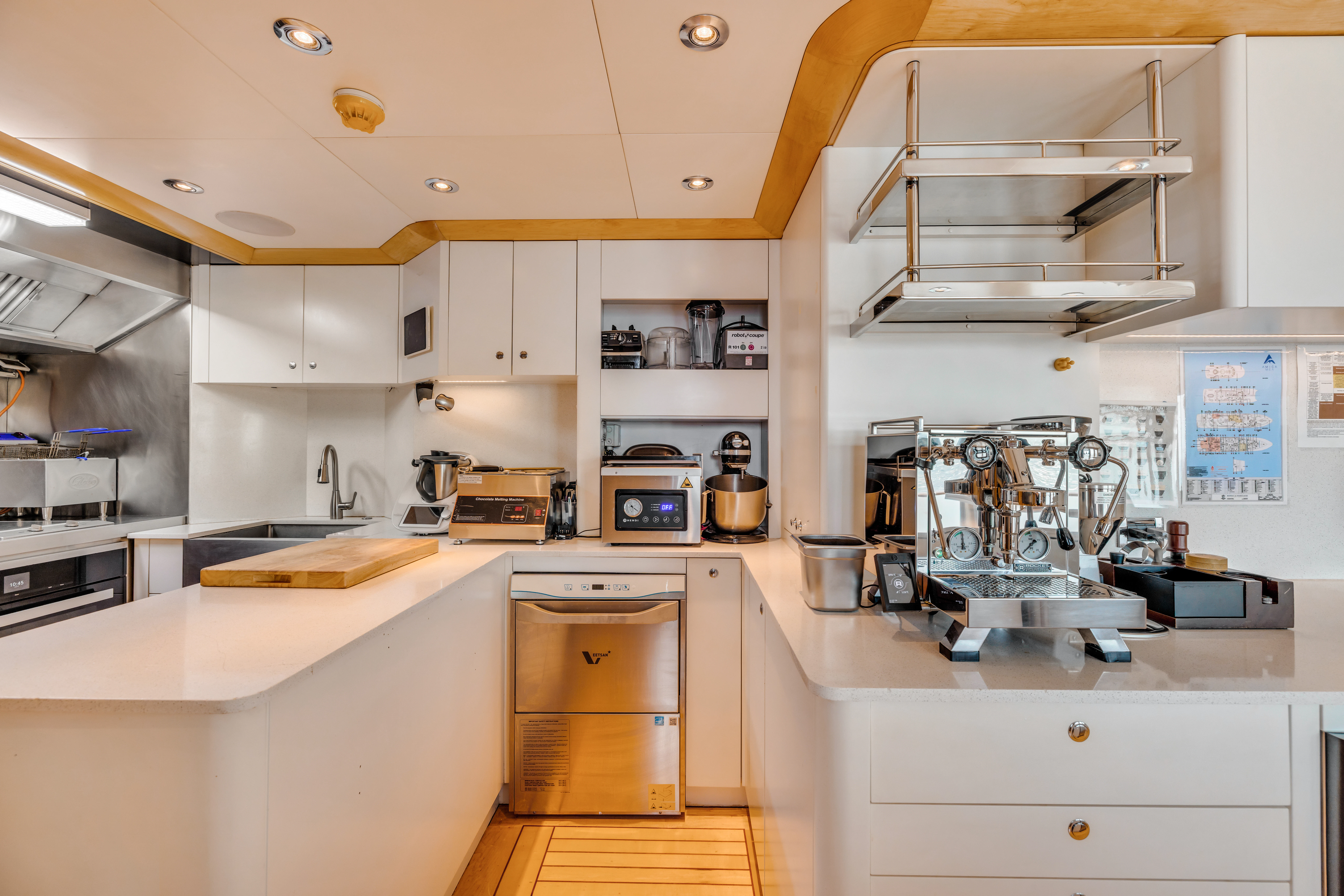a kitchen with white cabinets aboard AMICA MEA Yacht for Sale