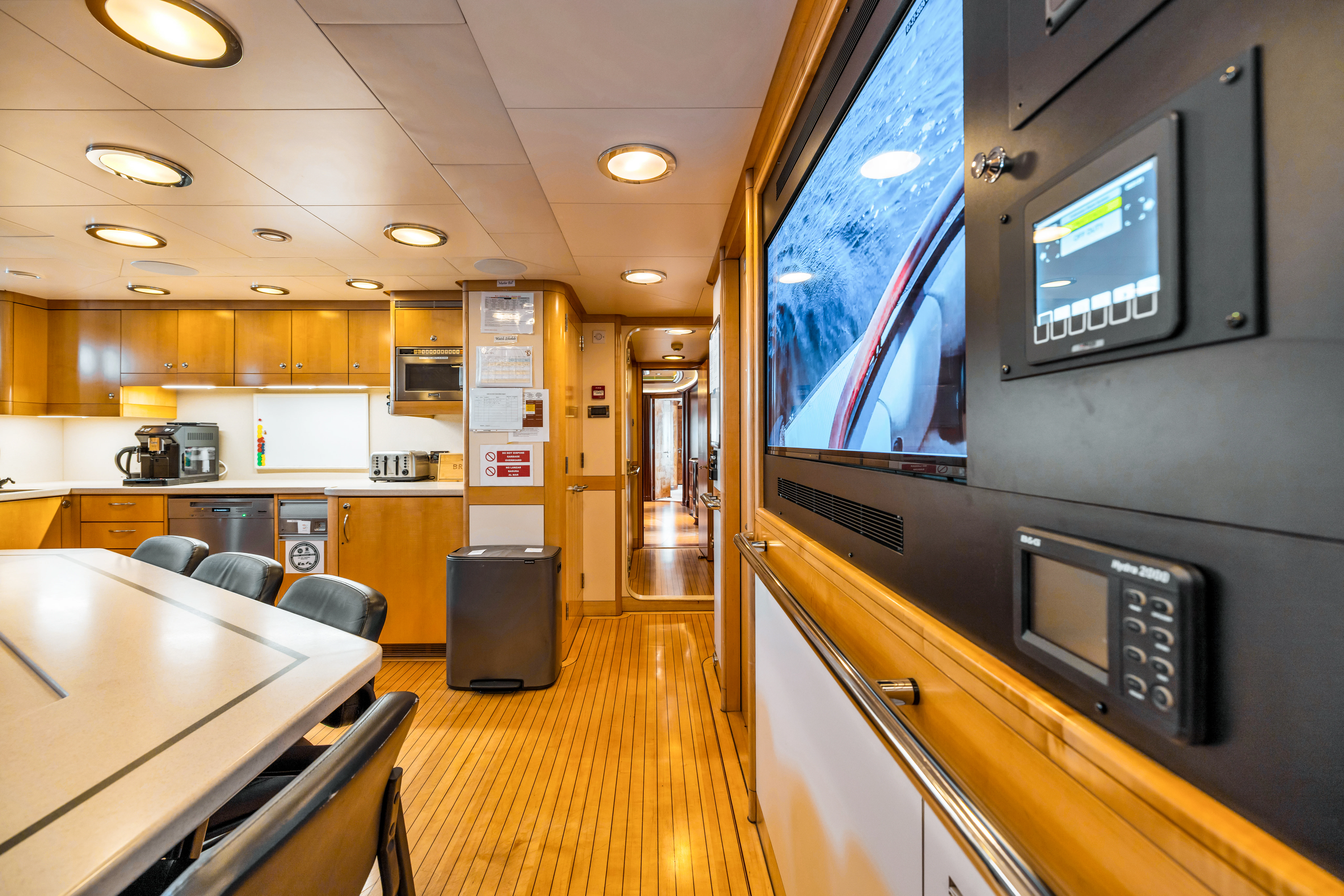 a large kitchen with a large screen aboard AMICA MEA Yacht for Sale