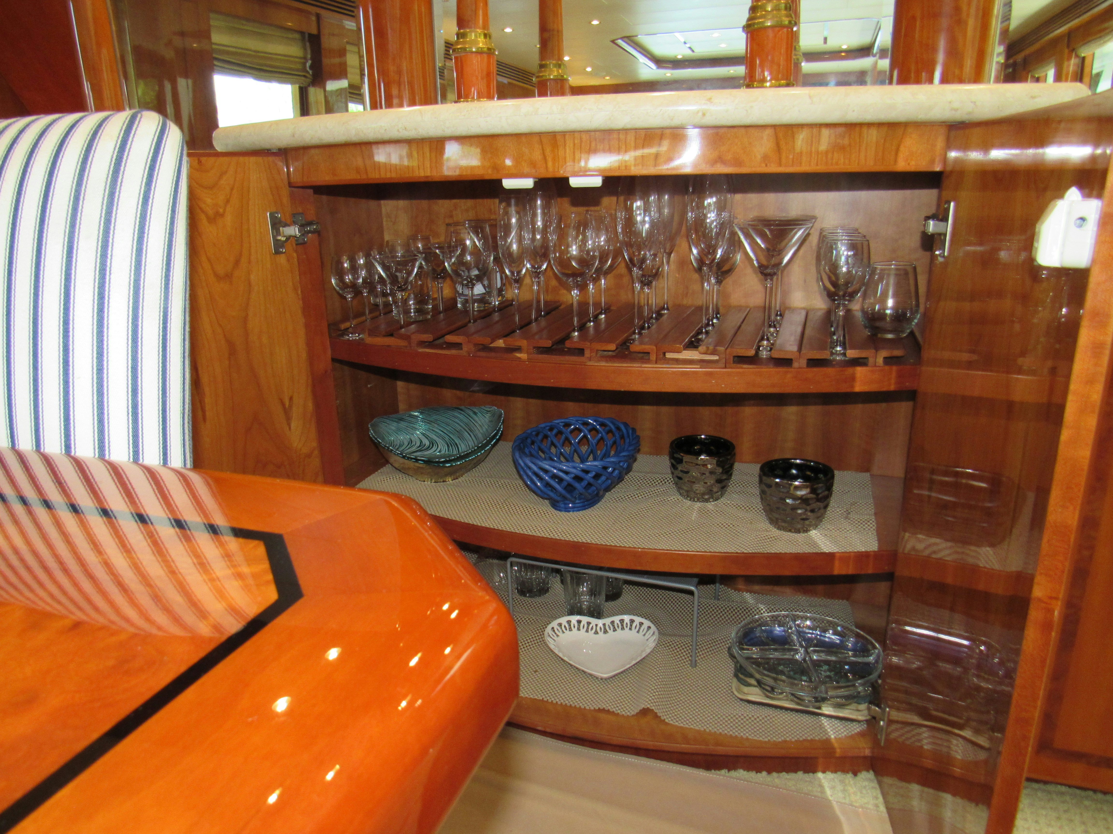 a shelf with many glasses and dishes on it aboard SANCTUARY Yacht for Sale