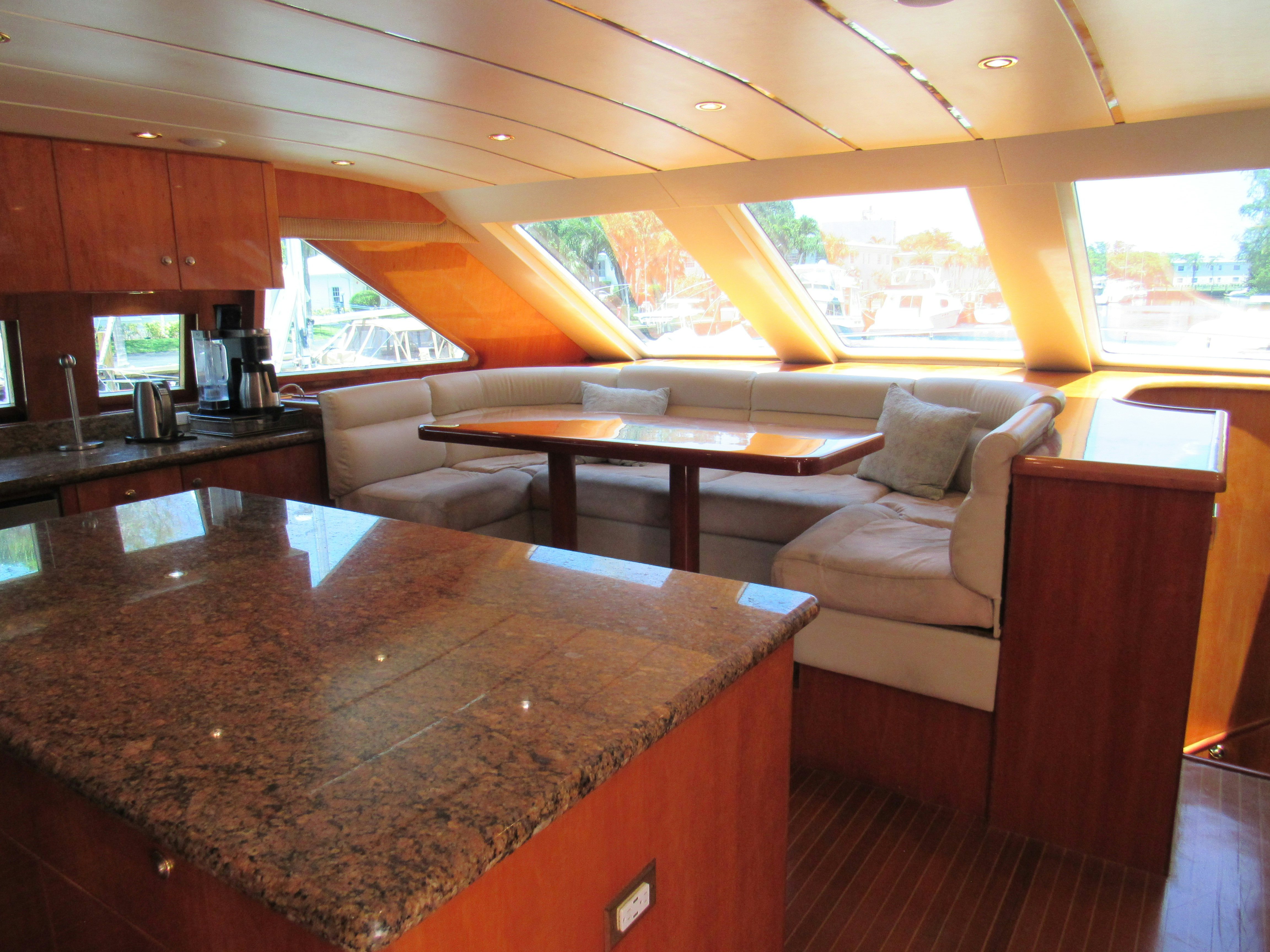 a large living room with a large table and couches aboard SANCTUARY Yacht for Sale