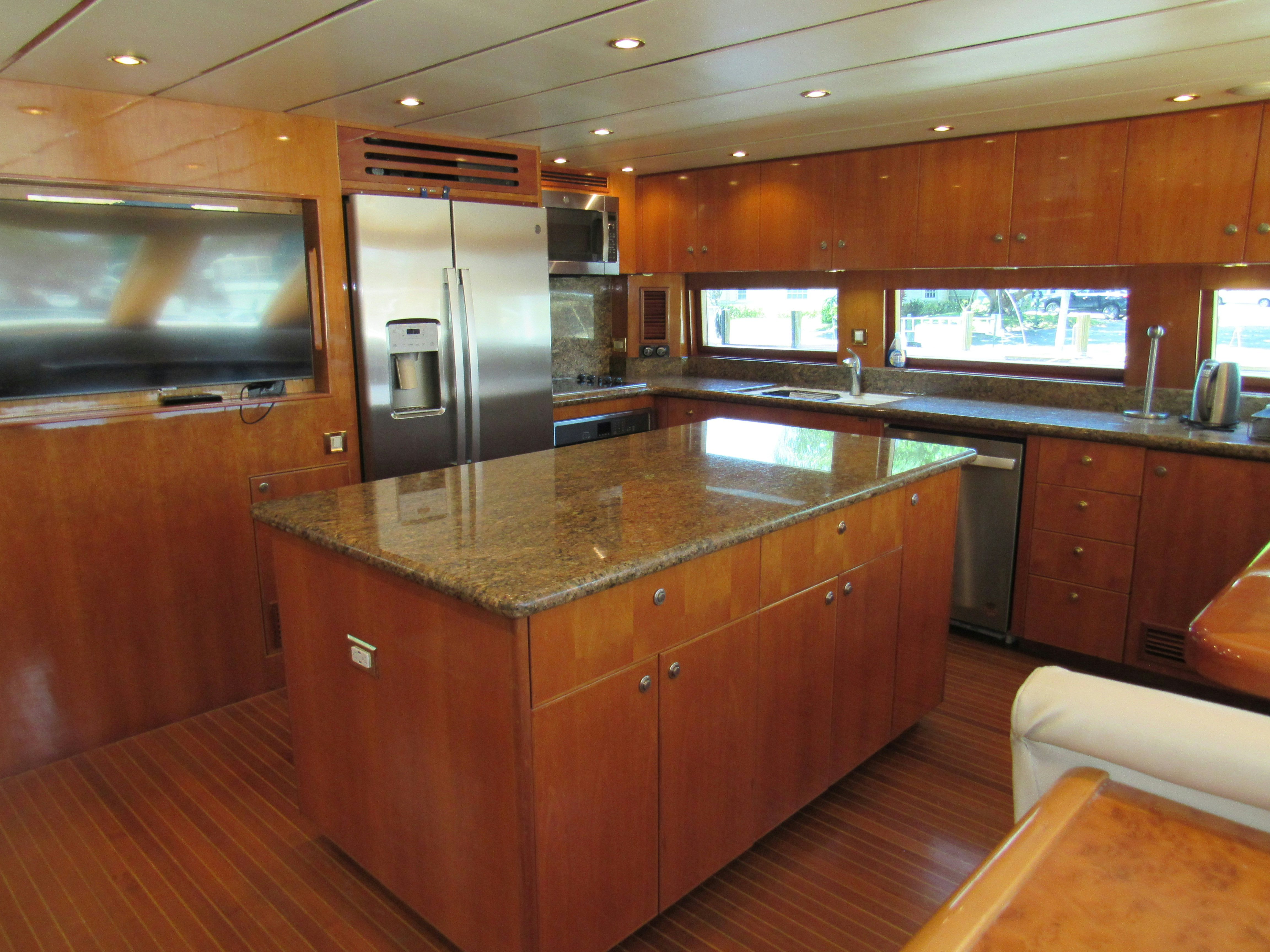 a kitchen with wooden cabinets aboard SANCTUARY Yacht for Sale