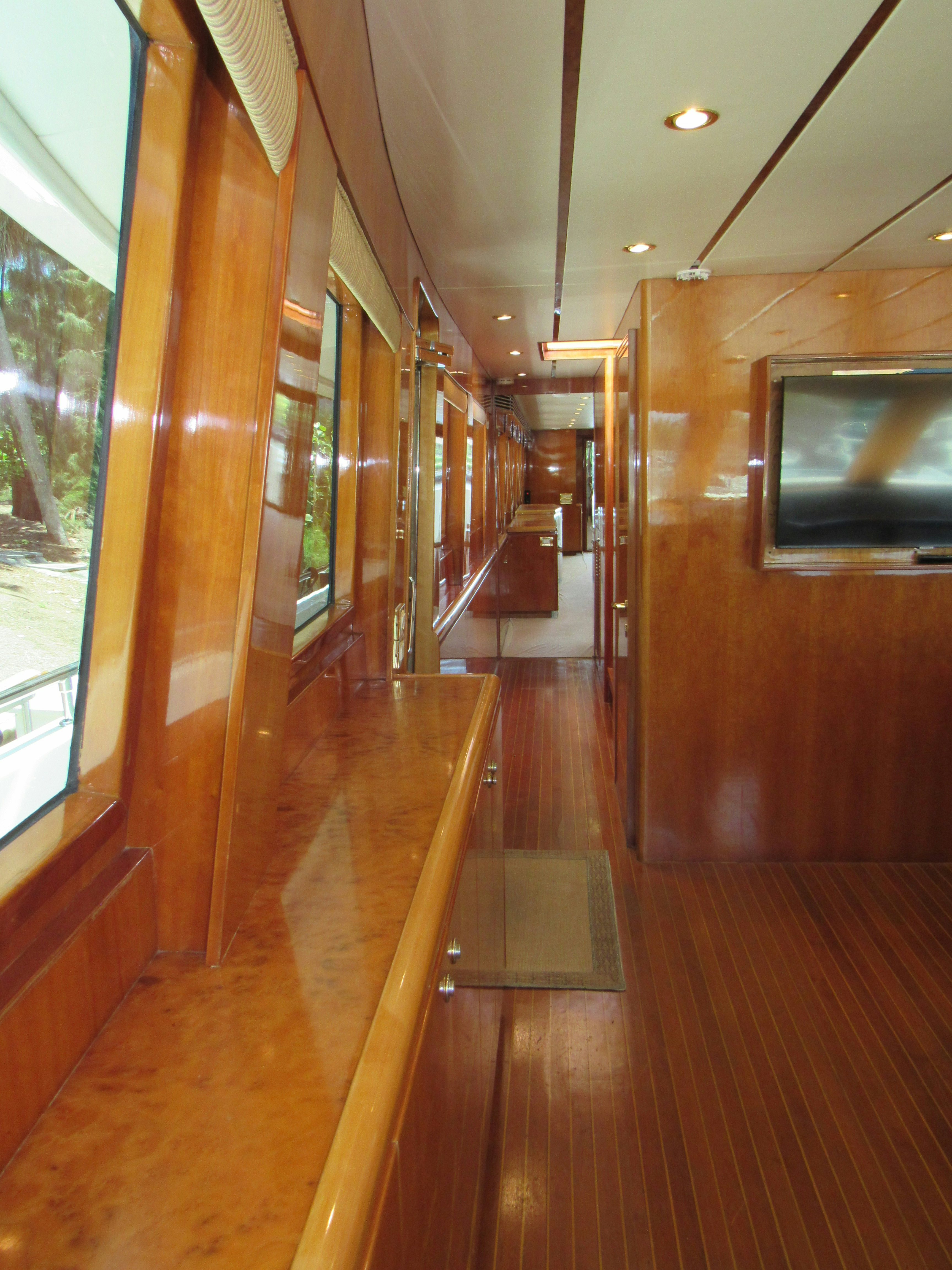 a room with a wood floor and a large window aboard SANCTUARY Yacht for Sale