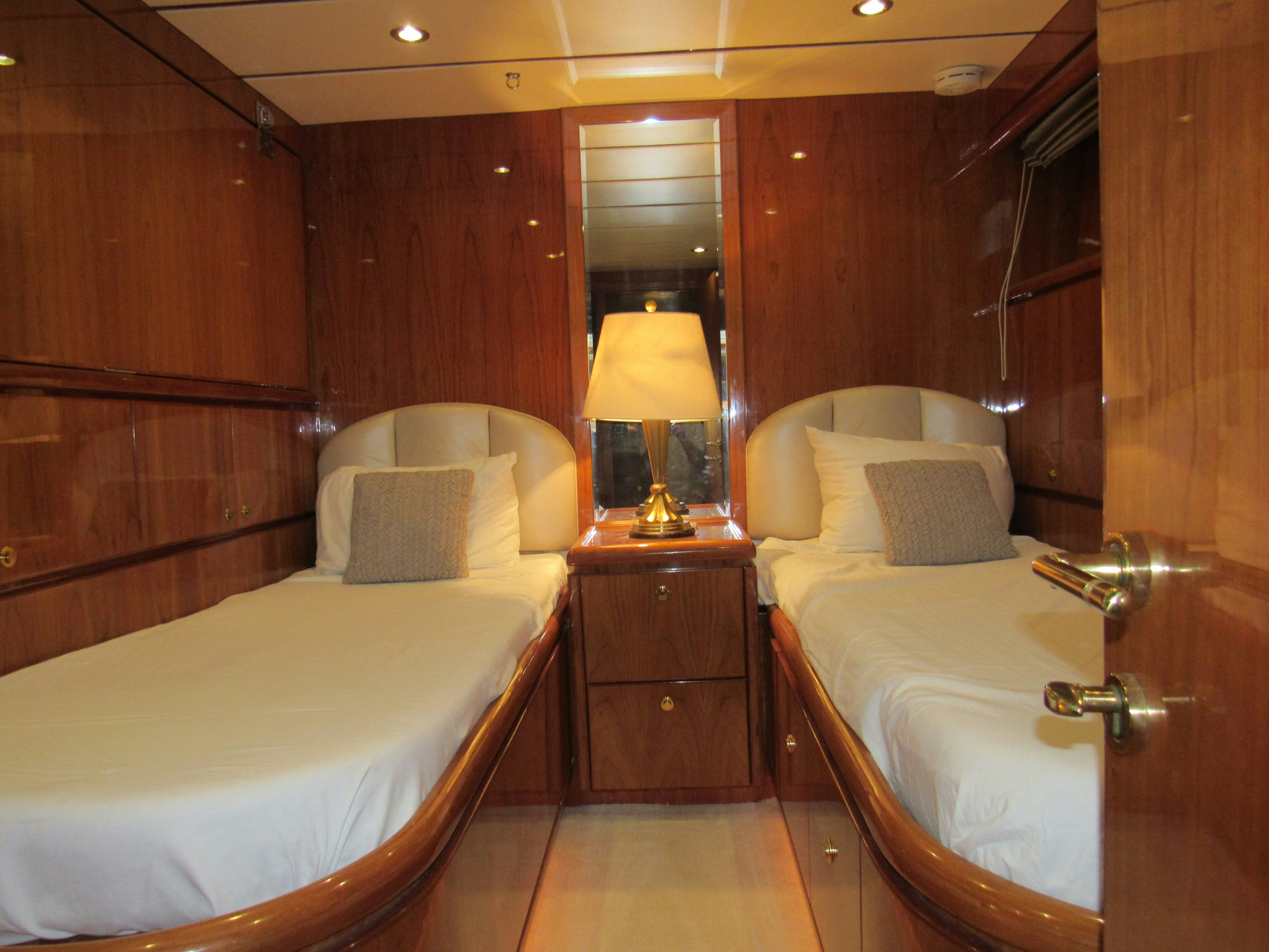 a room with a bed and a lamp aboard SANCTUARY Yacht for Sale