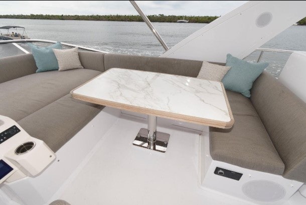 a couch with a table on it aboard ENDLESS SUMMER Yacht for Sale