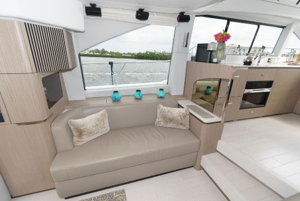 a living room with a couch and a window aboard ENDLESS SUMMER Yacht for Sale