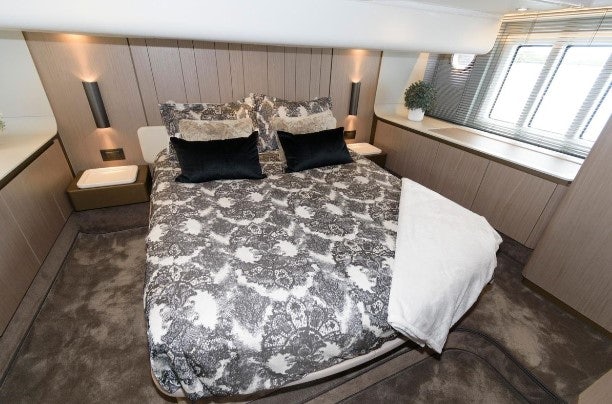 a large bed with white sheets aboard ENDLESS SUMMER Yacht for Sale