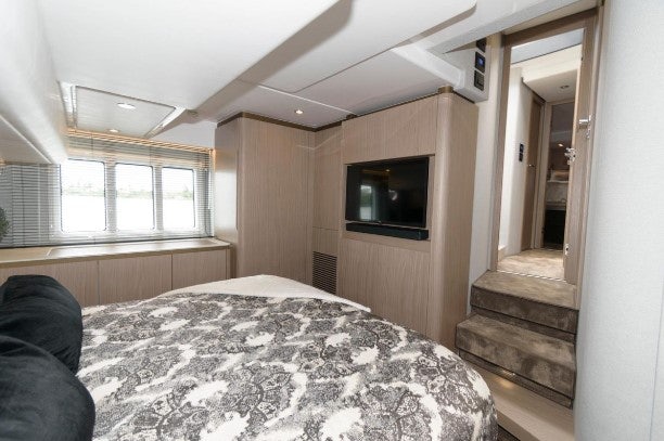 a bedroom with a bed and a television aboard ENDLESS SUMMER Yacht for Sale
