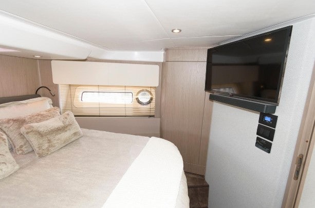 a bedroom with a bed and a television aboard ENDLESS SUMMER Yacht for Sale