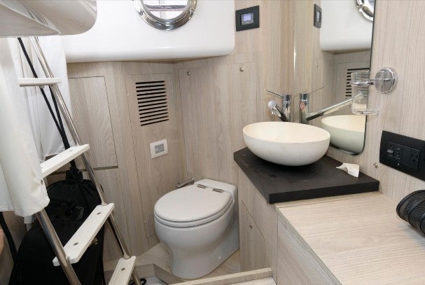 a bathroom with a sink toilet and a mirror aboard ENDLESS SUMMER Yacht for Sale
