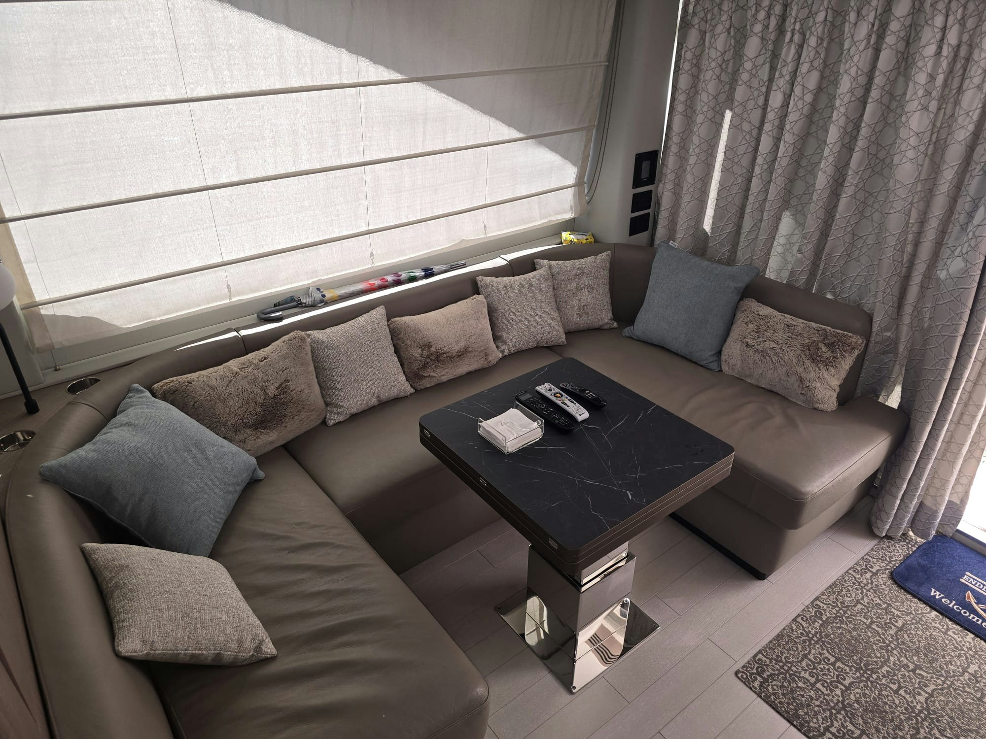 a living room with a couch and coffee table aboard ENDLESS SUMMER Yacht for Sale