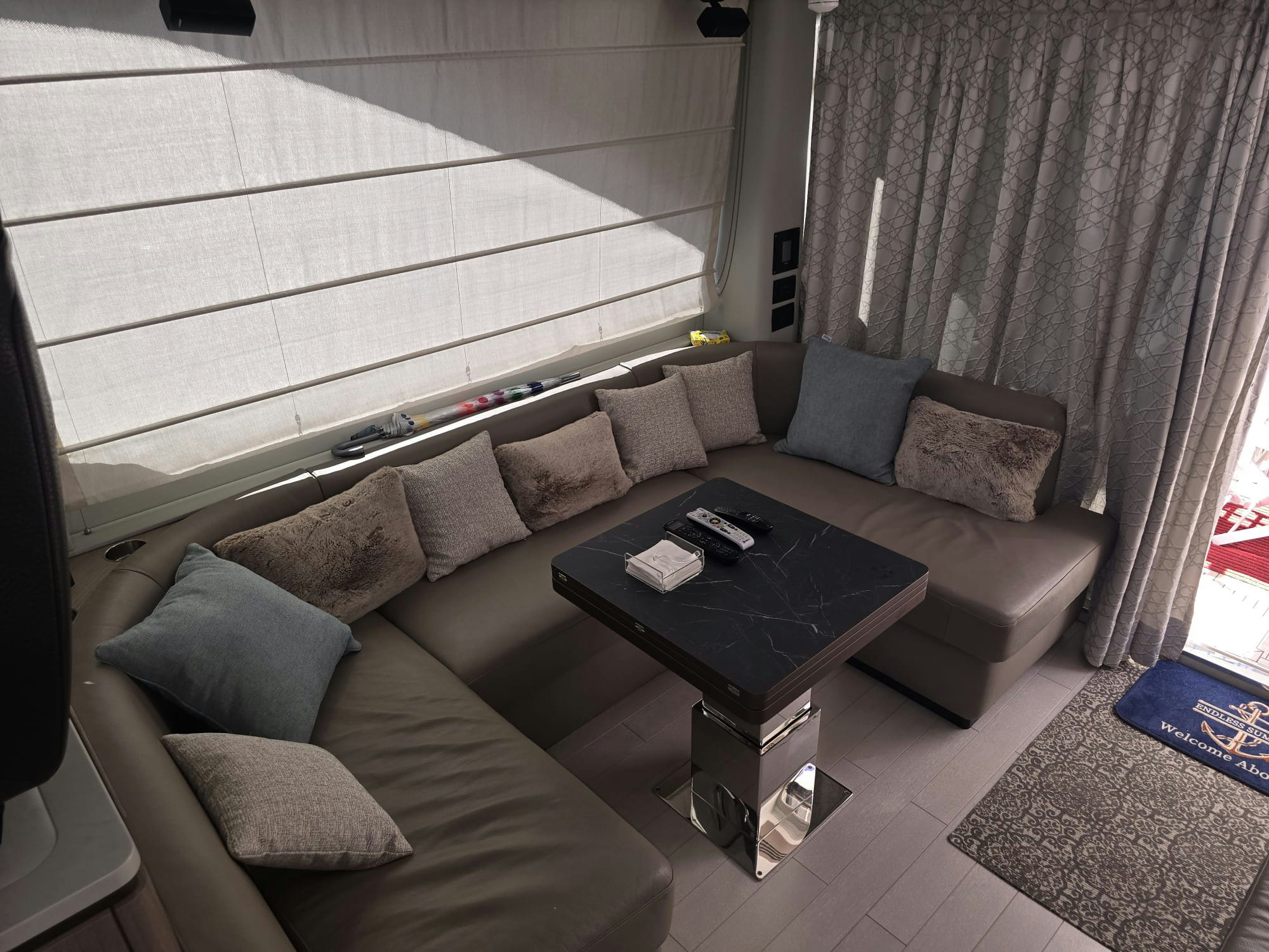 a living room with a couch and coffee table aboard ENDLESS SUMMER Yacht for Sale