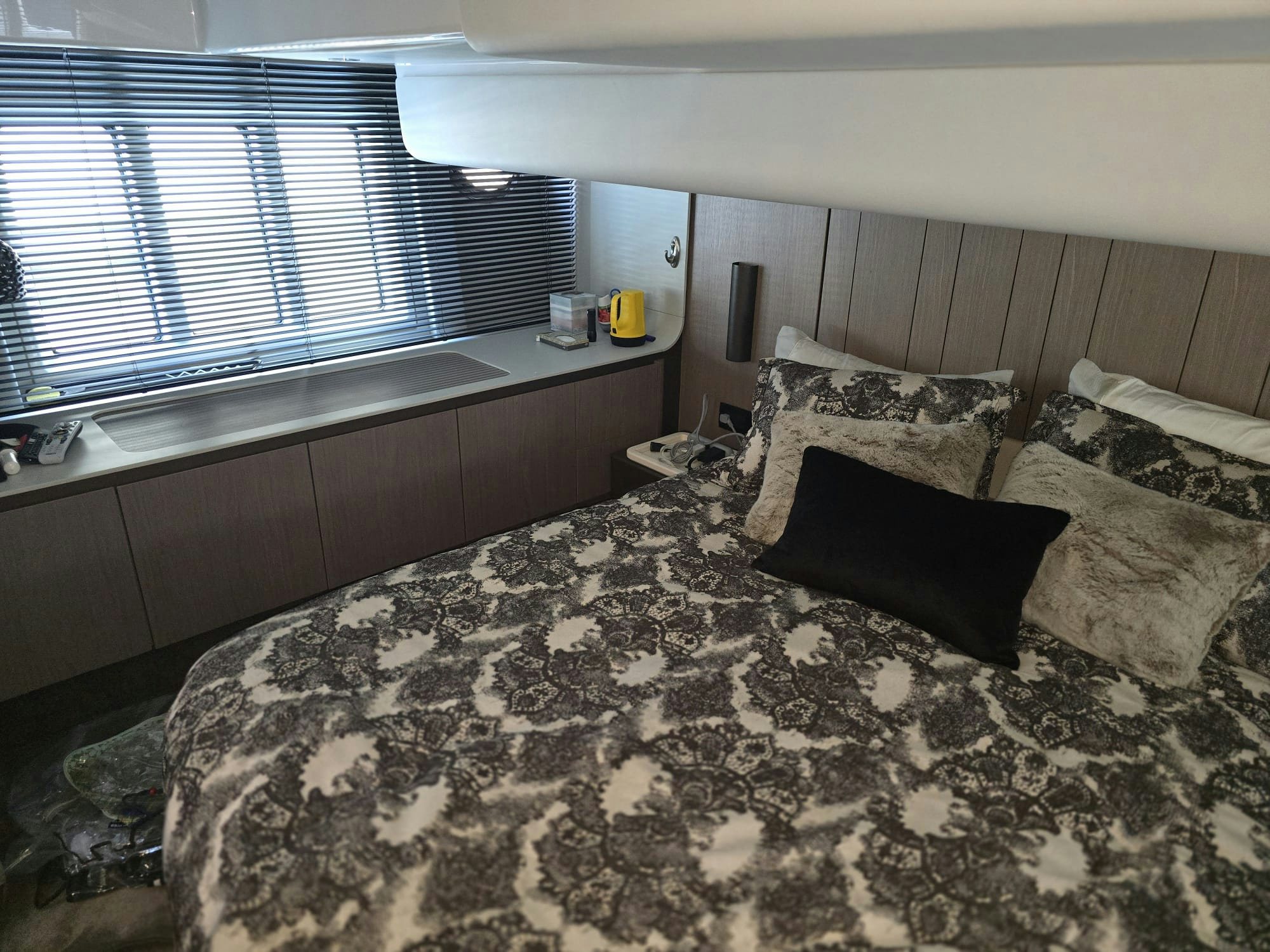 a bed with a black and white bed spread aboard ENDLESS SUMMER Yacht for Sale