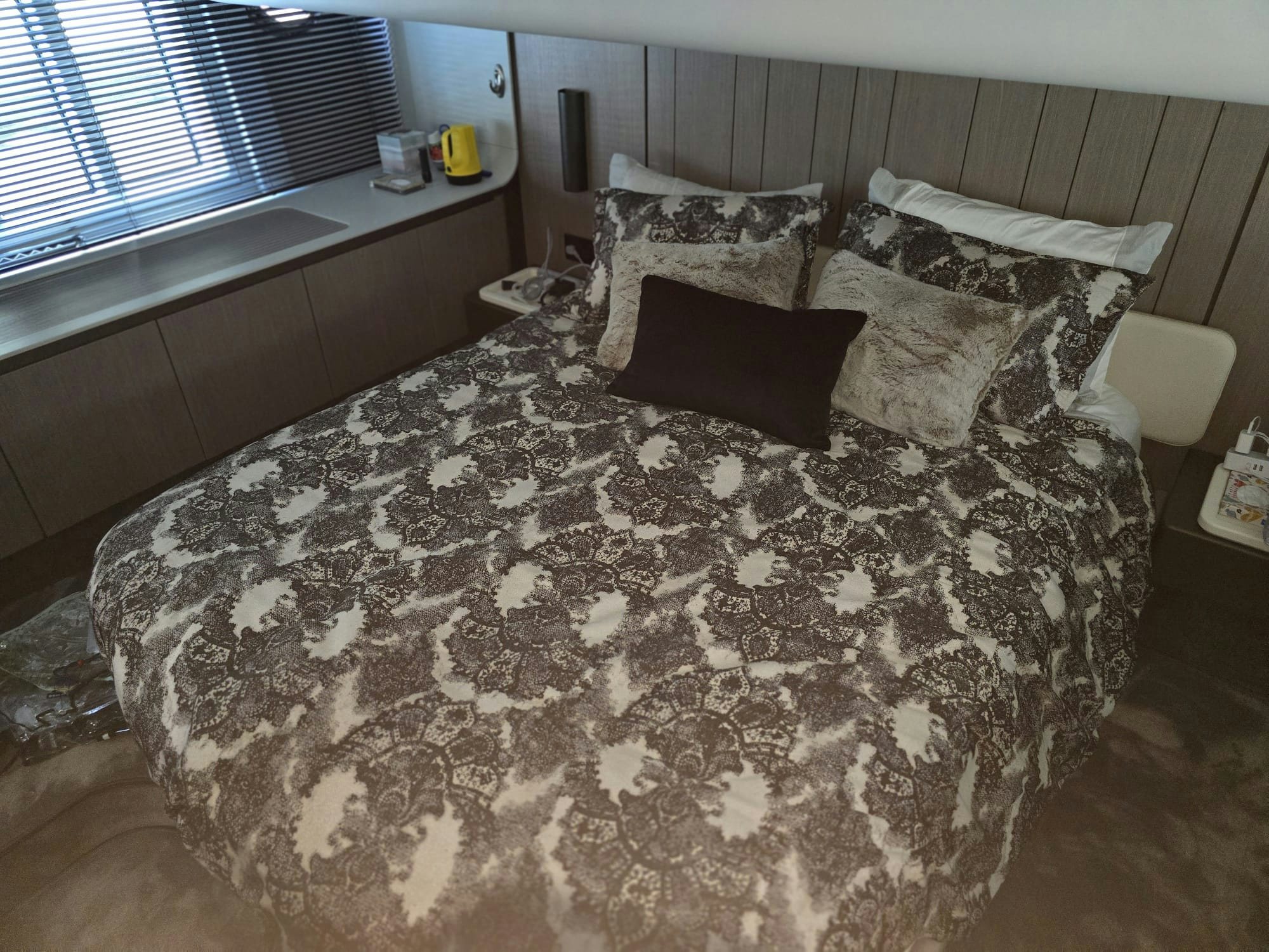 a bed with a black and white comforter and pillows aboard ENDLESS SUMMER Yacht for Sale