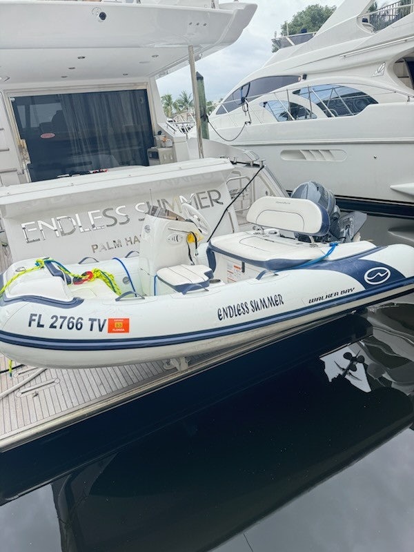 a boat with a motor attached to it aboard ENDLESS SUMMER Yacht for Sale