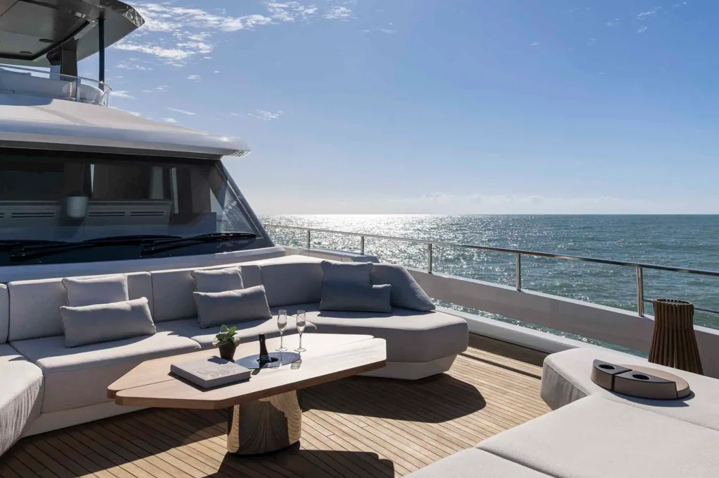 a room with a couch and a table and a view of the ocean aboard ILMA Yacht for Charter