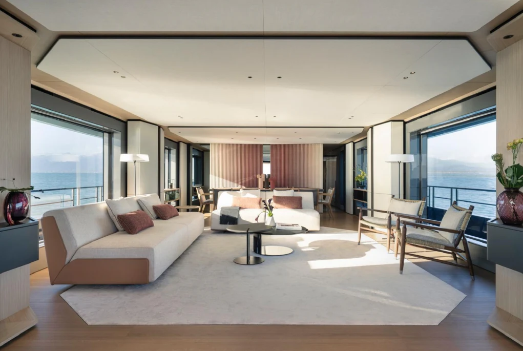a living room with a large white rug and a large white table aboard ILMA Yacht for Charter