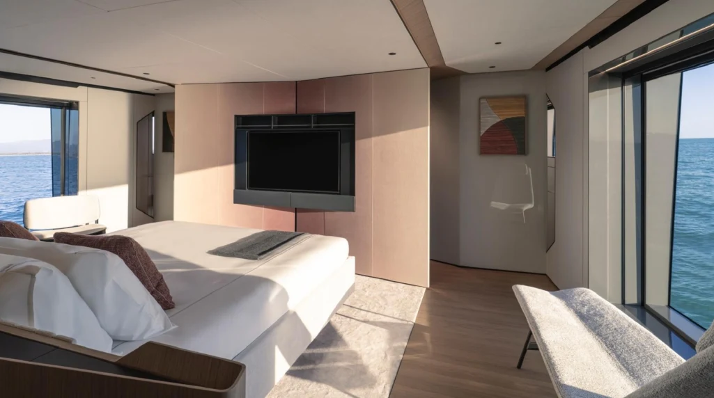a bedroom with a large tv aboard ILMA Yacht for Charter