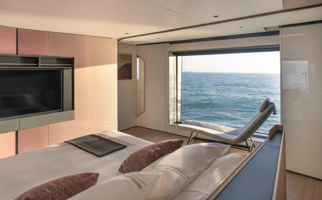 a room with a bed and a television aboard ILMA Yacht for Charter