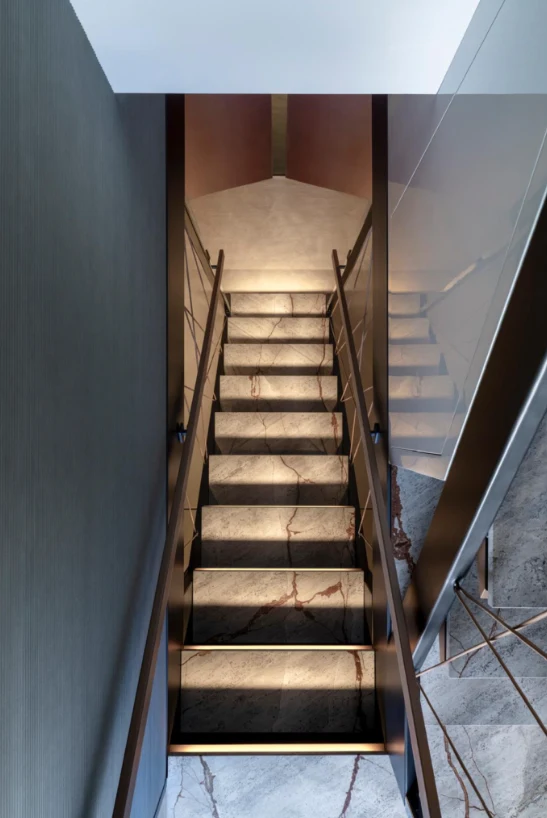 a wooden staircase with a black and white striped floor aboard ILMA Yacht for Charter
