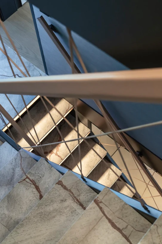 a wooden staircase with a metal frame aboard ILMA Yacht for Charter