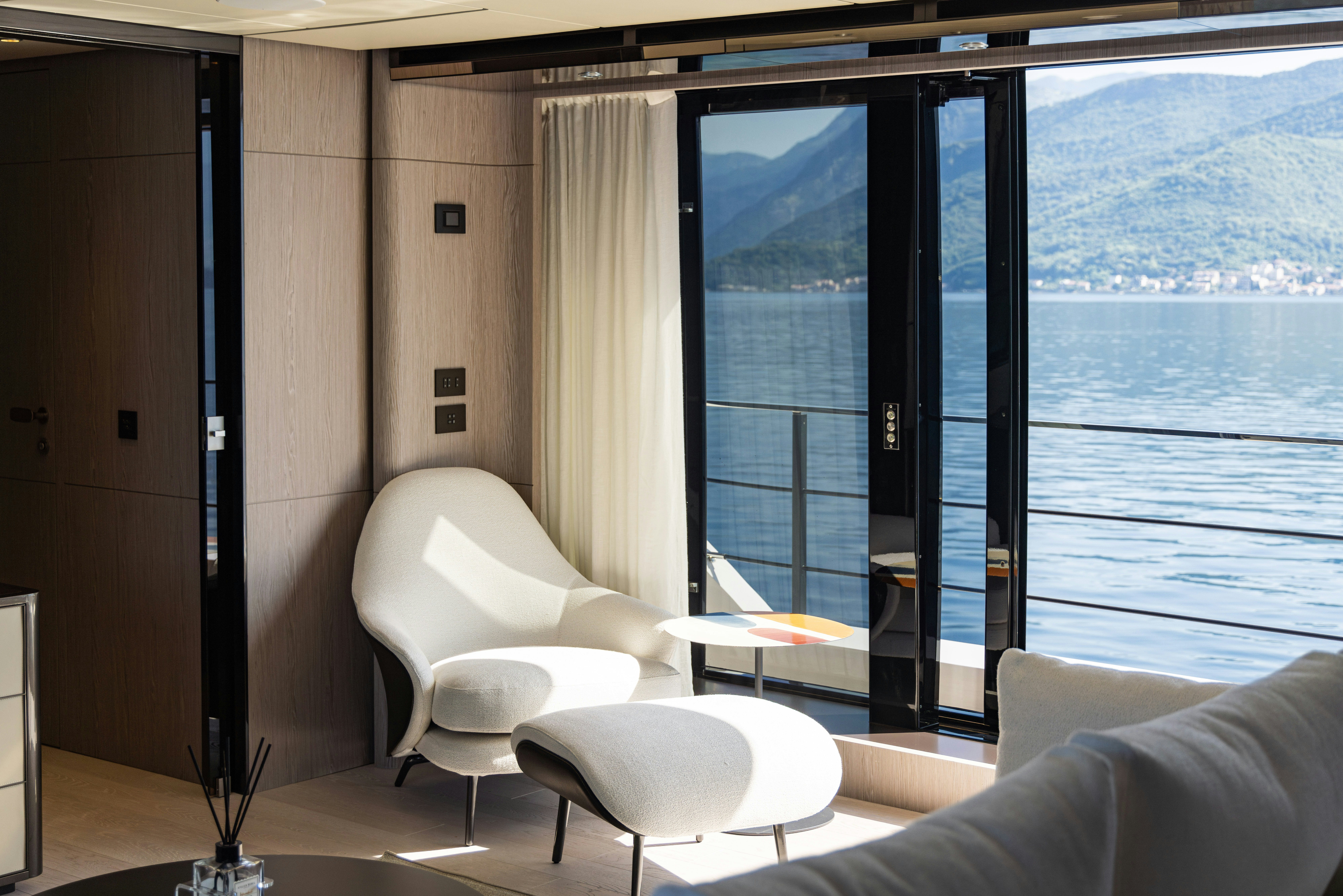 a room with a view of a city and a large window aboard FIFI Yacht for Charter