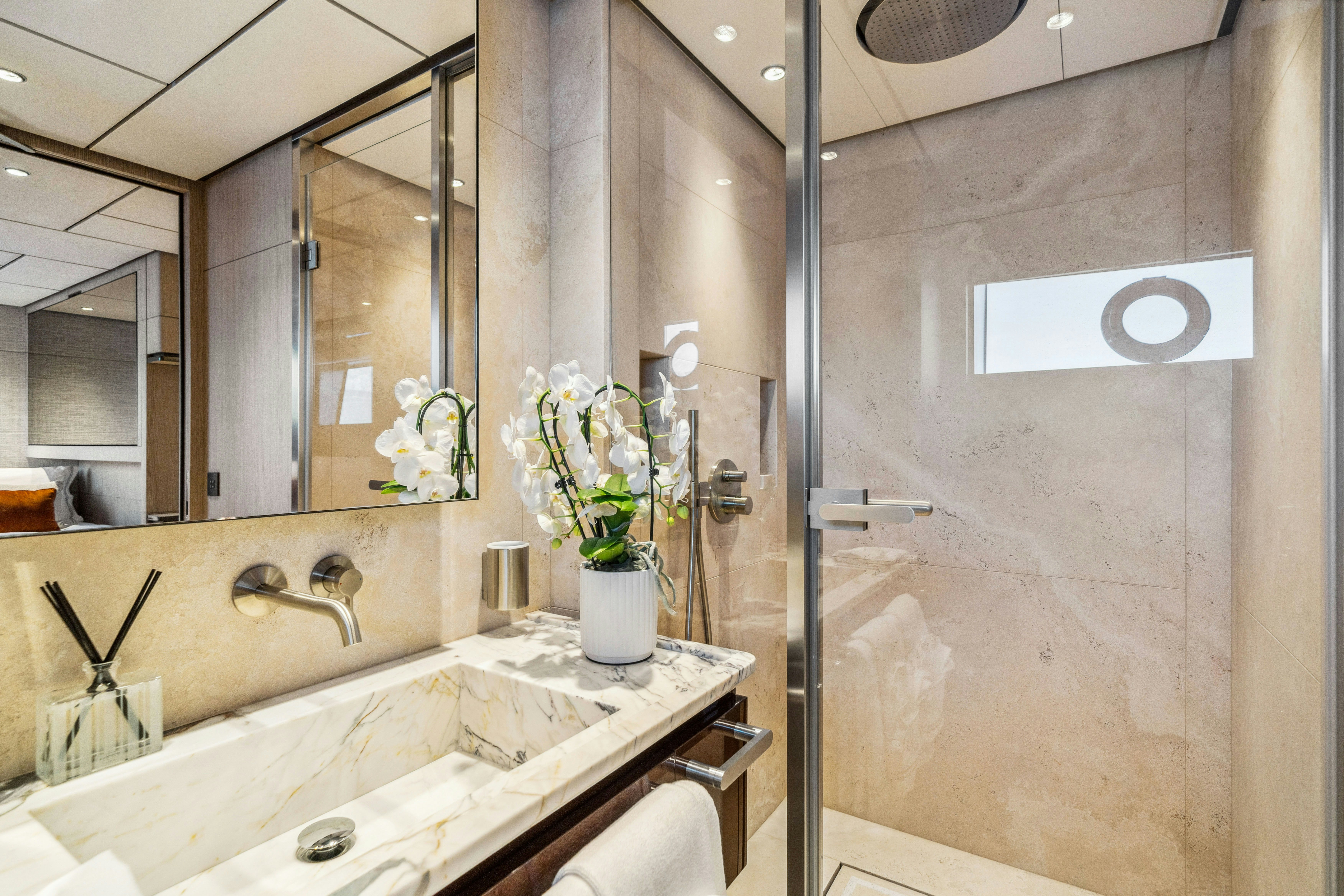 a bathroom with a glass shower aboard FIFI Yacht for Charter