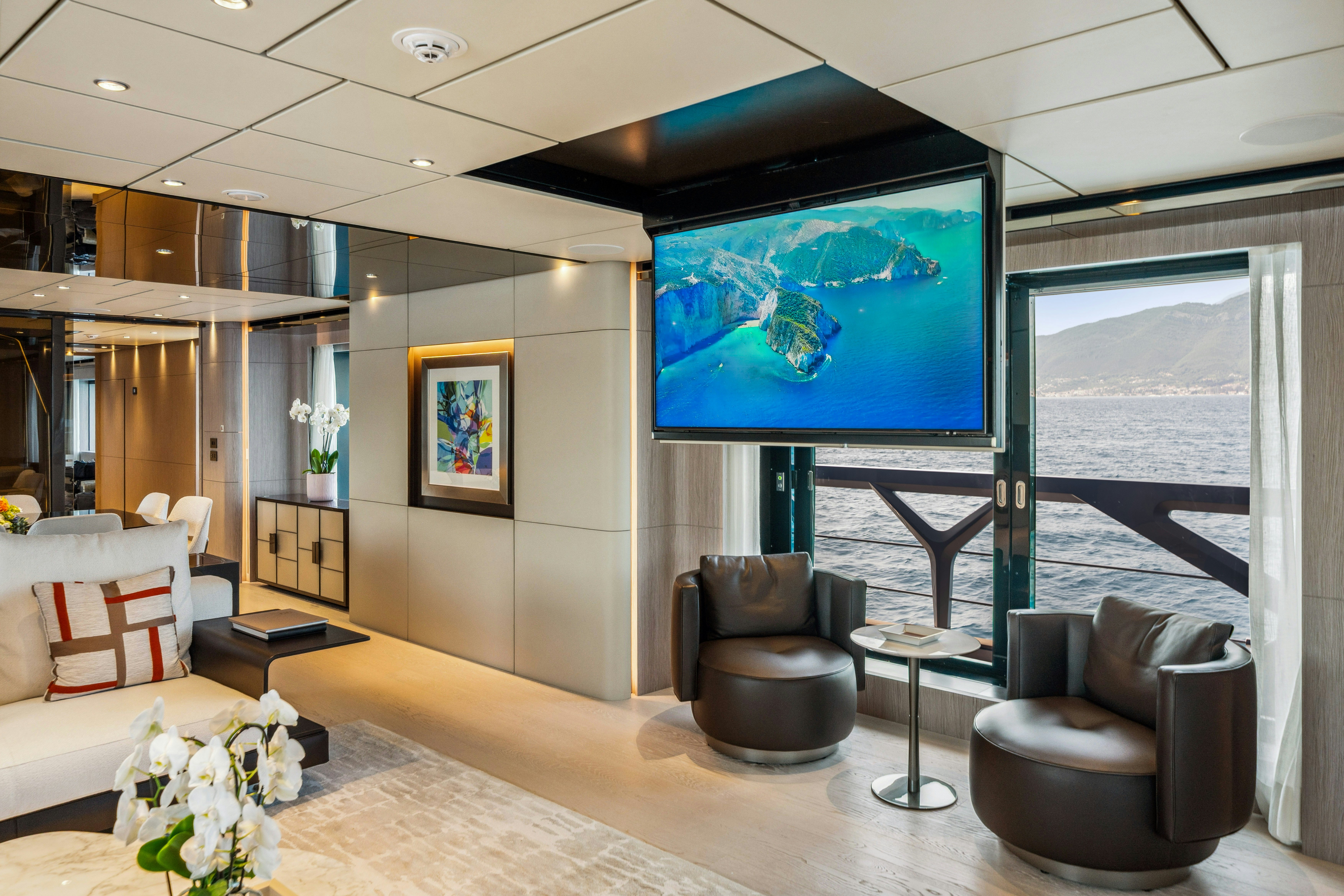 a living room with a large screen aboard FIFI Yacht for Charter